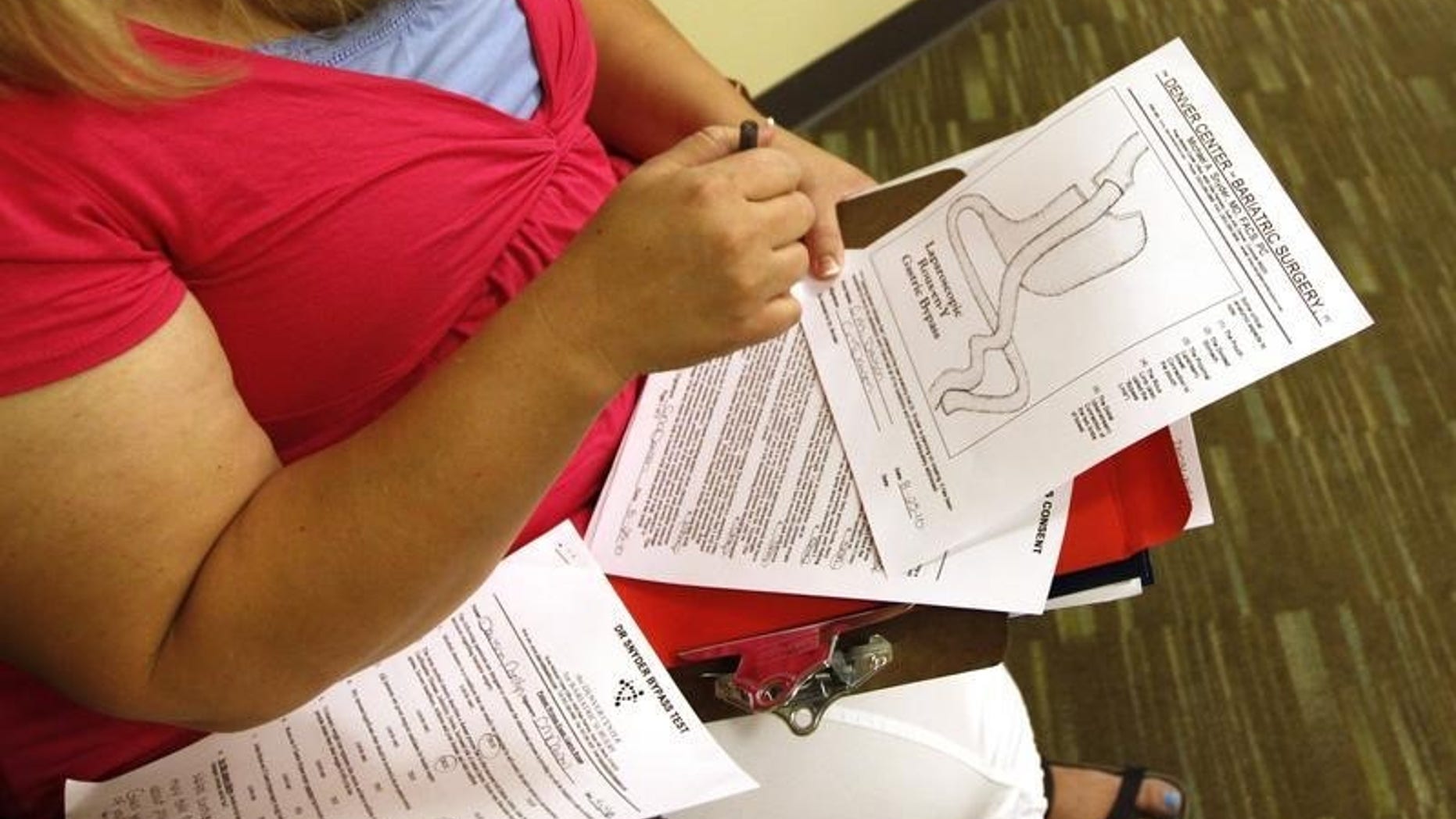Carolyn Dawson, bariatric surgery patient looks at a diagram of her procedure at her surgeon Dr. Michael Snyder's office in Denver five days before her operation August 25, 2010. REUTERS/Rick Wilking