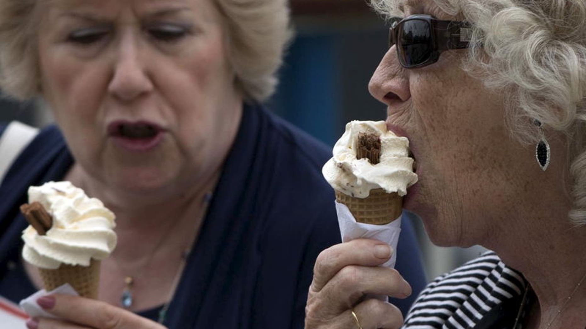 Women eat ice cream cones in London, Britain, in this photograph taken on August 29, 2015. REUTERS/Neil Hall
