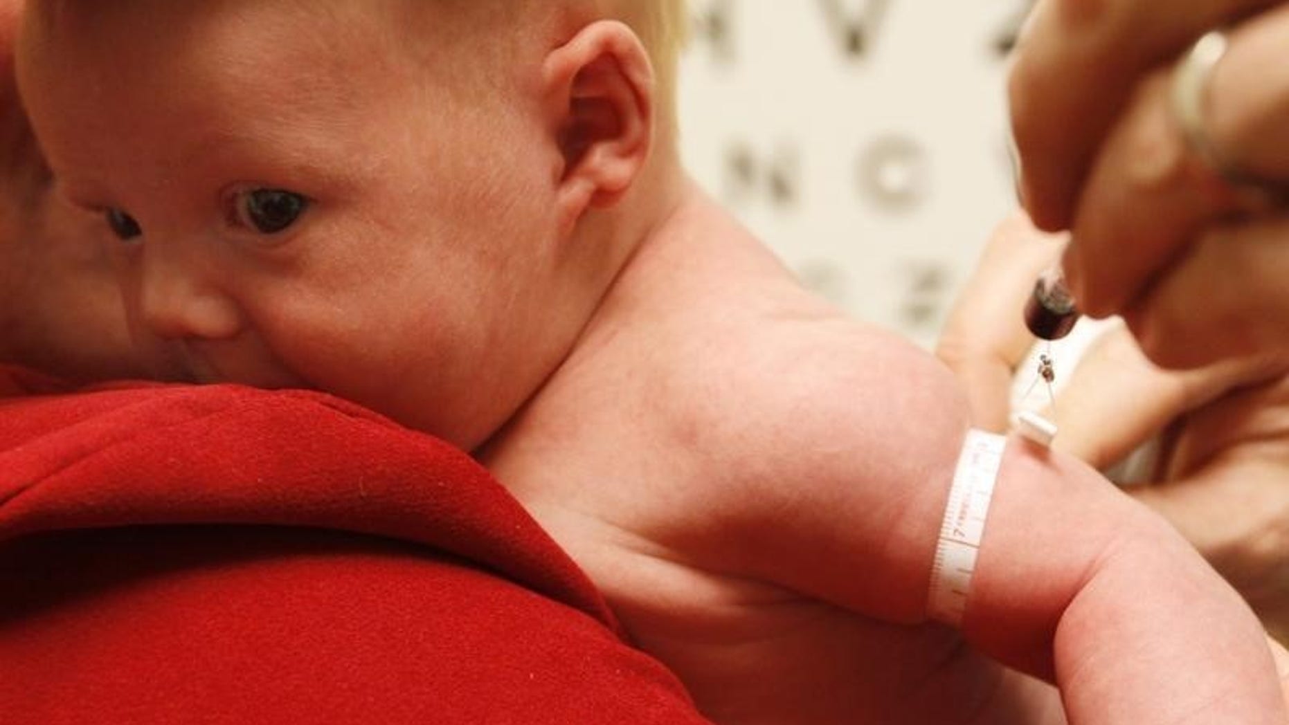 Michael Grabinski, two weeks old, has his arm measured at The Children's Hospital in Aurora, Colorado August 23, 2010 during a research study on obesity in infants. REUTERS/Rick Wilking