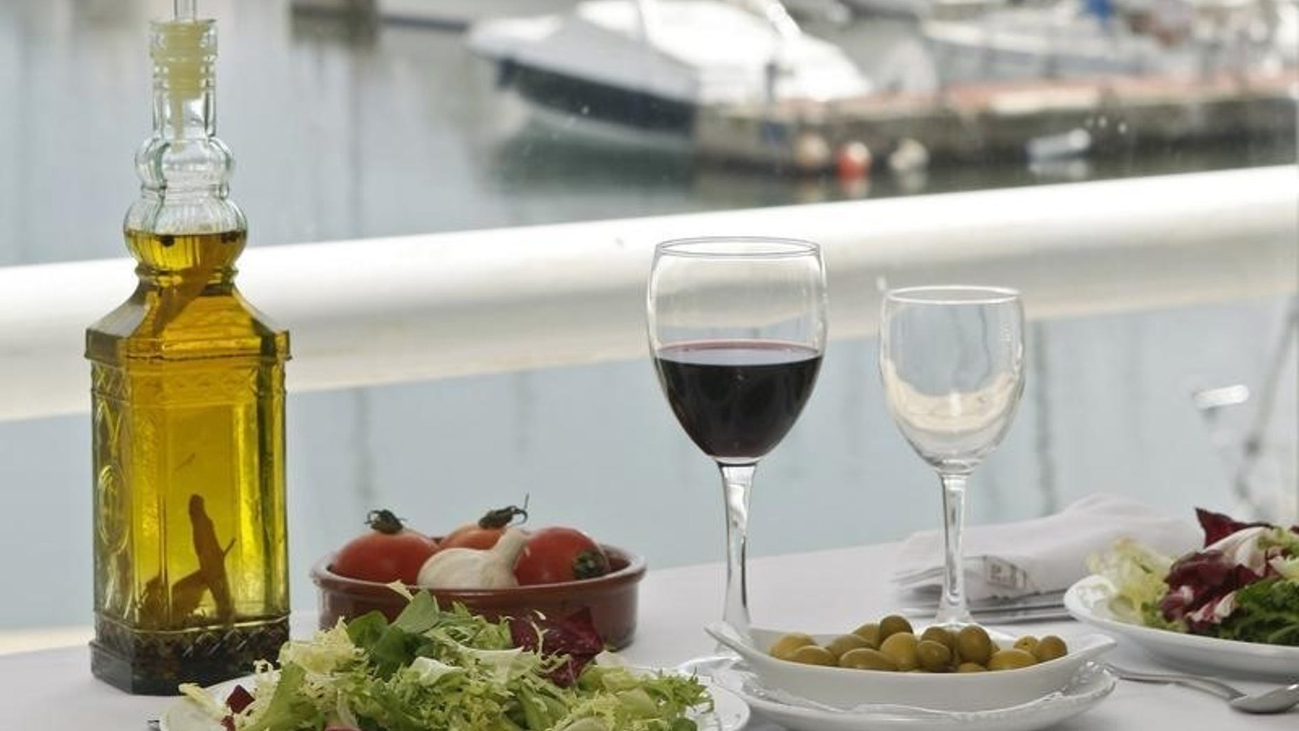 Food is seen on a table at a restaurant at the port of El Masnou, near Barcelona May 16, 2008. REUTERS/Albert Gea