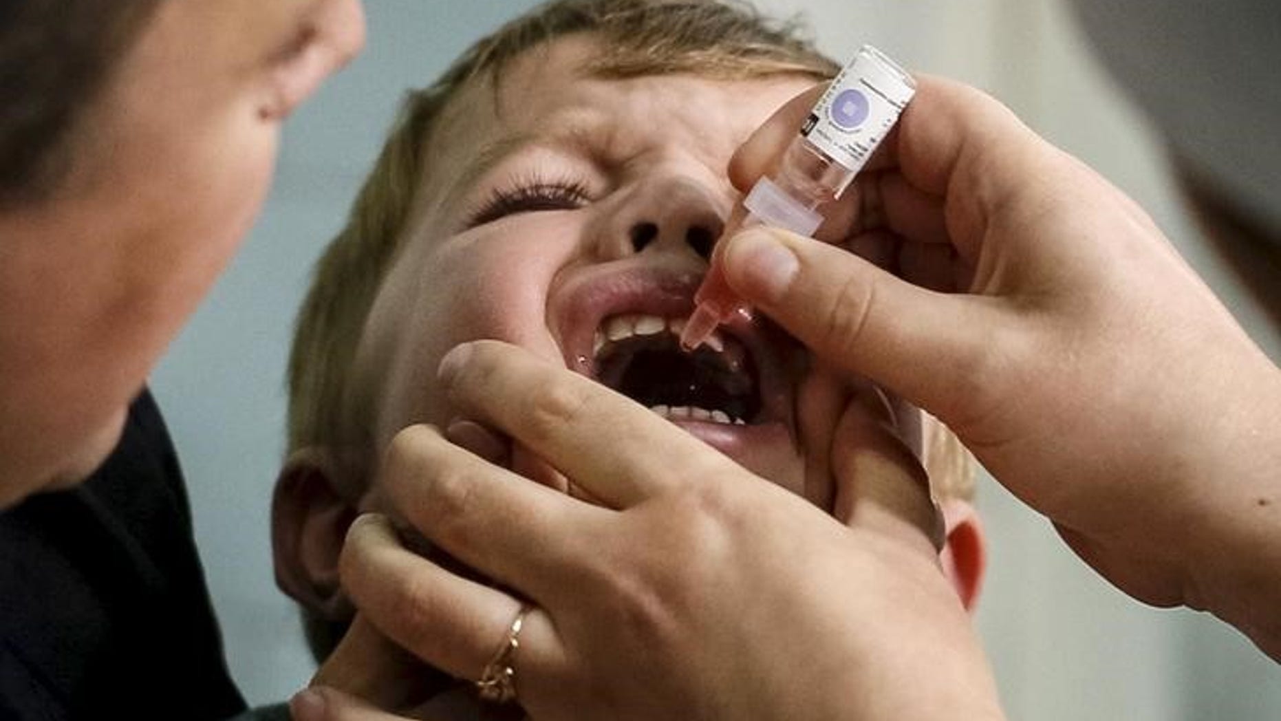 A boy receives polio vaccine drops at a clinic in Kiev, Ukraine, October 21, 2015. REUTERS/Gleb Garanich
