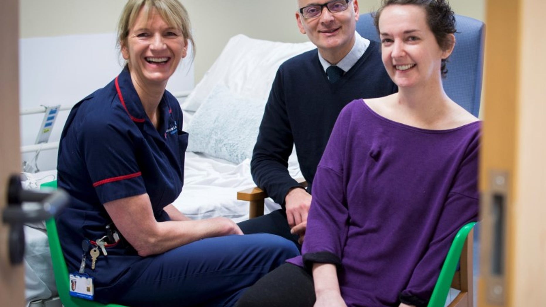 Pauline Cafferkey (R) smiles alongside Doctor Michael Jacobs and Senior Matron Breda Athan at the Royal Free Hospital in London, November 11, 2015. REUTERS/Royal Free Hospital/Handout