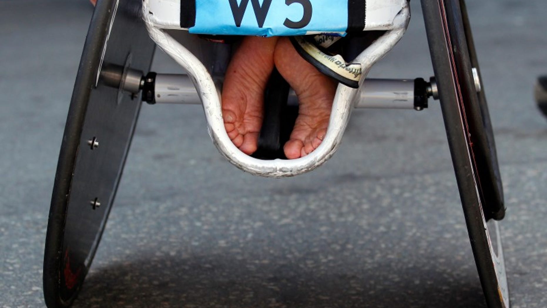 The feet of an athlete are tucked into his wheelchair at the 116th Boston Marathon in Boston, Massachusetts April 16, 2012. REUTERS/Brian Snyder