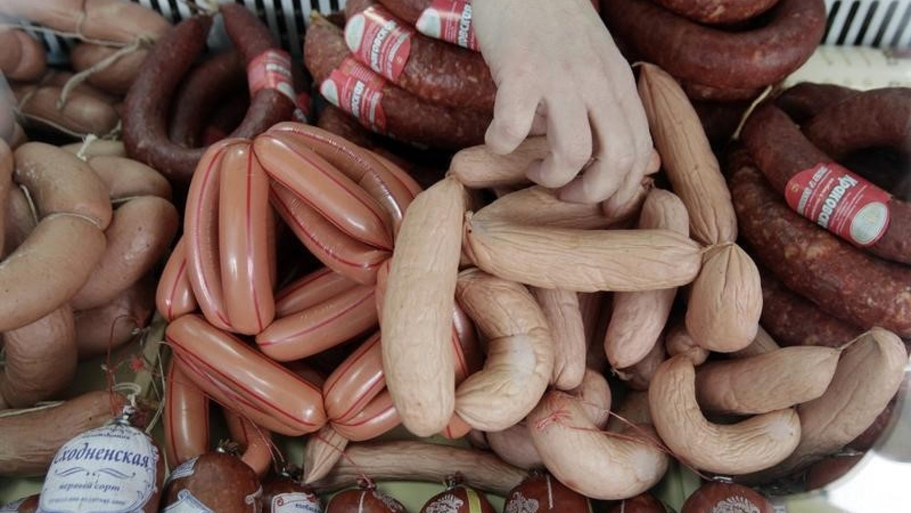 A vendor sells sausages prepared at a local sausage shop of the "Russia" collective farm in the settlement of Grigoropolisskaya, northwest of the southern city of Stavropol, February 17, 2015. REUTERS/Eduard Korniyenko