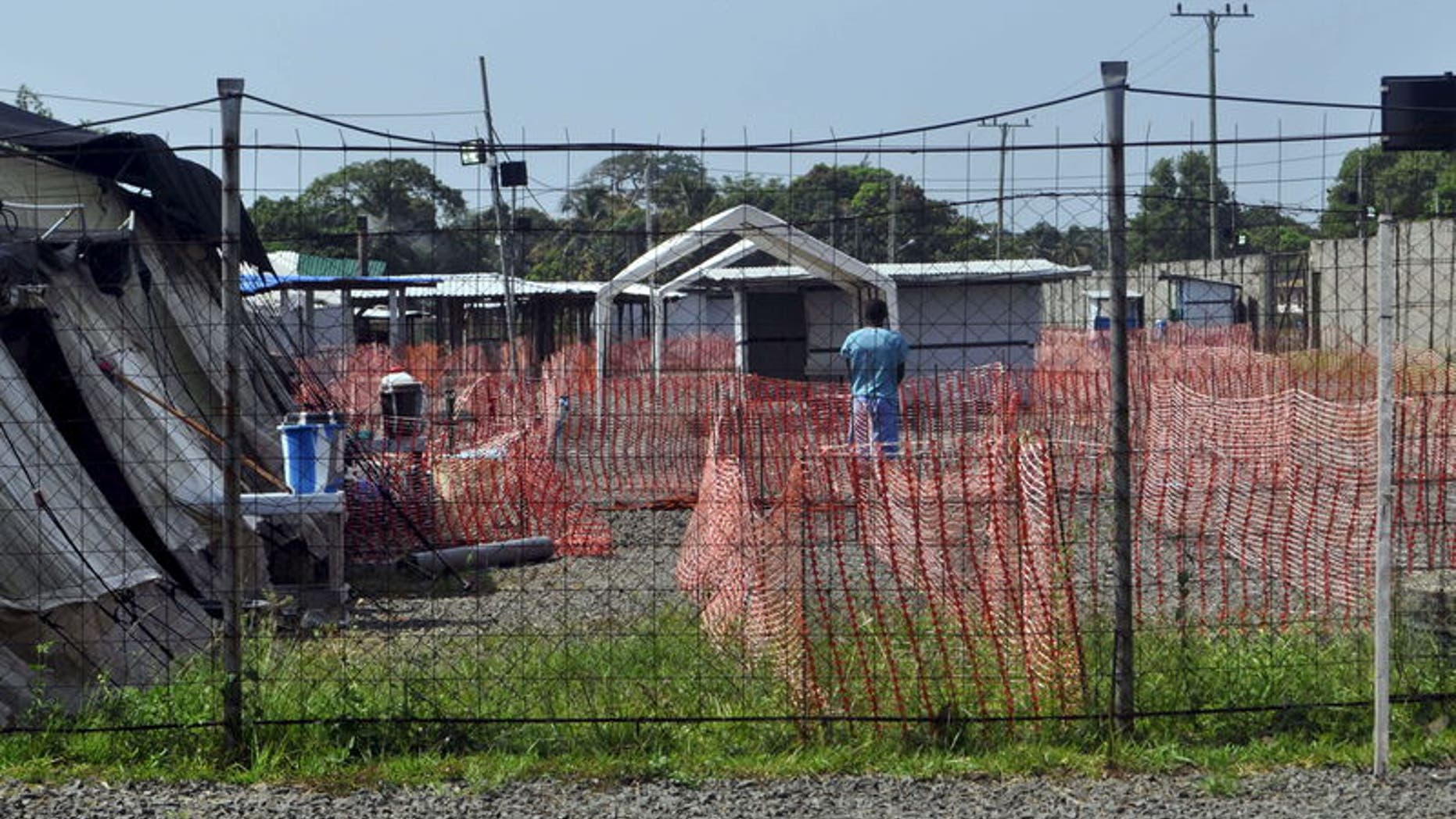 A health worker stands in the Ebola virus treatment center where three people are currently being treated in Paynesville, Liberia, November 23, 2015. REUTERS/James Giahyue