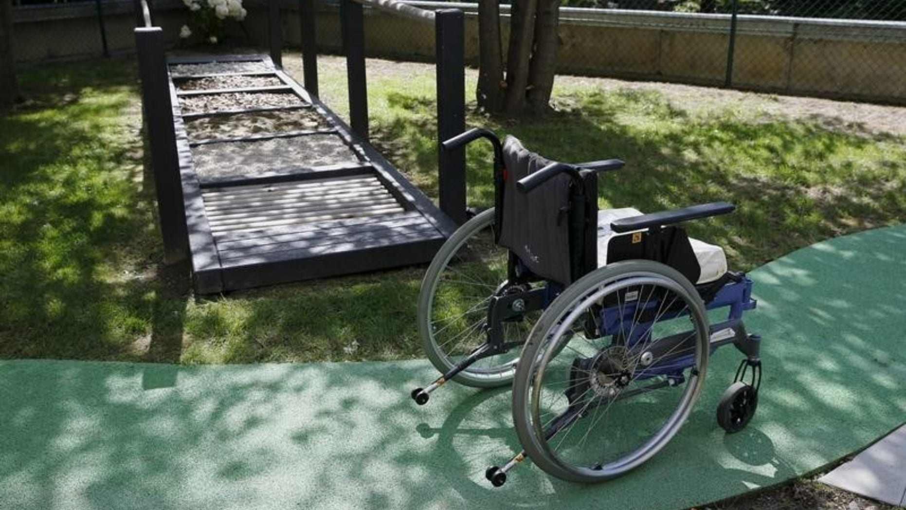 A wheelchair is pictured next to a walking frame during a media presentation in the 300-square-metre therapeutic garden of the Acute Neurological Rehabilitation Unit at Lausanne University Hospital (CHUV) in Lausanne, Switzerland, August 25, 2015. REUTERS/Denis Balibouse