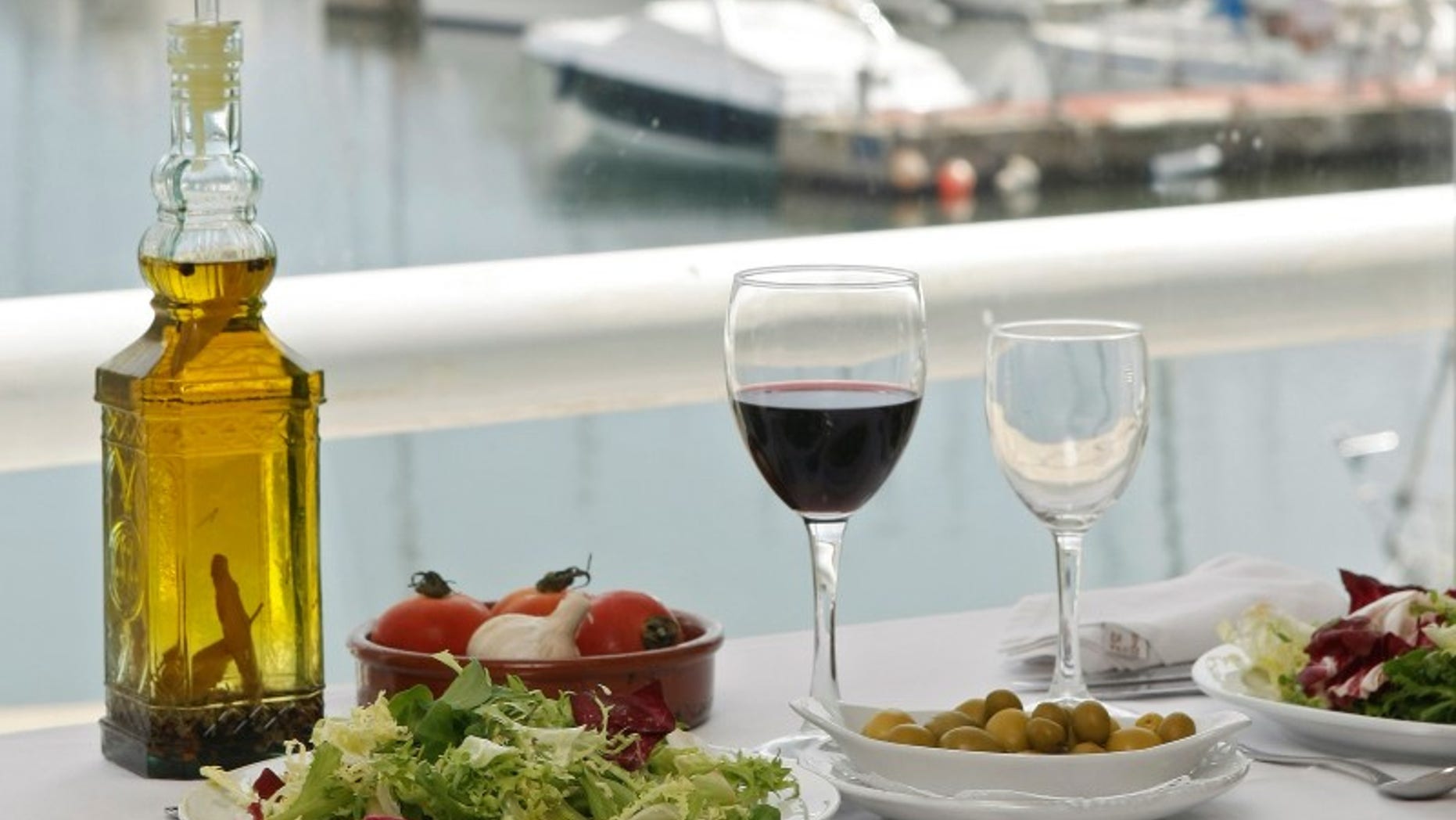 Food is seen on a table at a restaurant at the port of El Masnou, near Barcelona May 16, 2008. REUTERS/Albert Gea