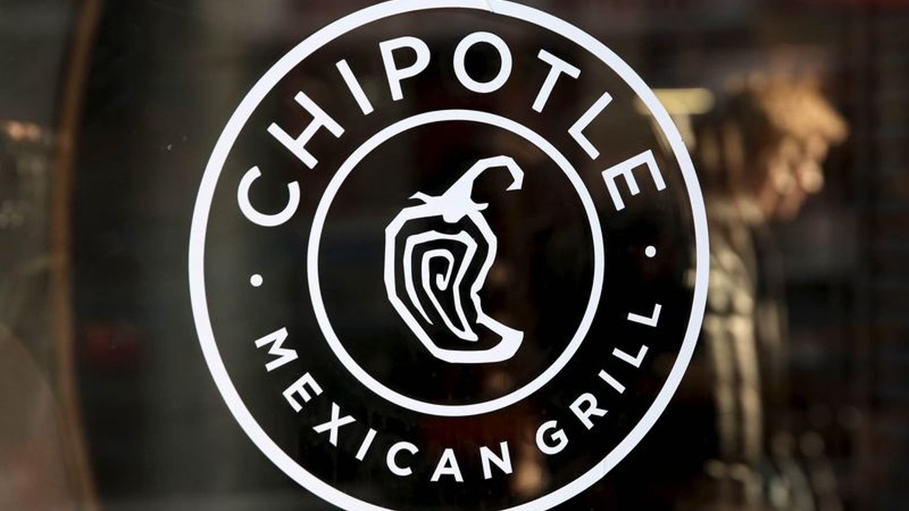A logo of Chipotle Mexican Grill is seen on a store entrance in Manhattan, New York in this November 23, 2015 file photo. REUTERS/Andrew Kelly/Files