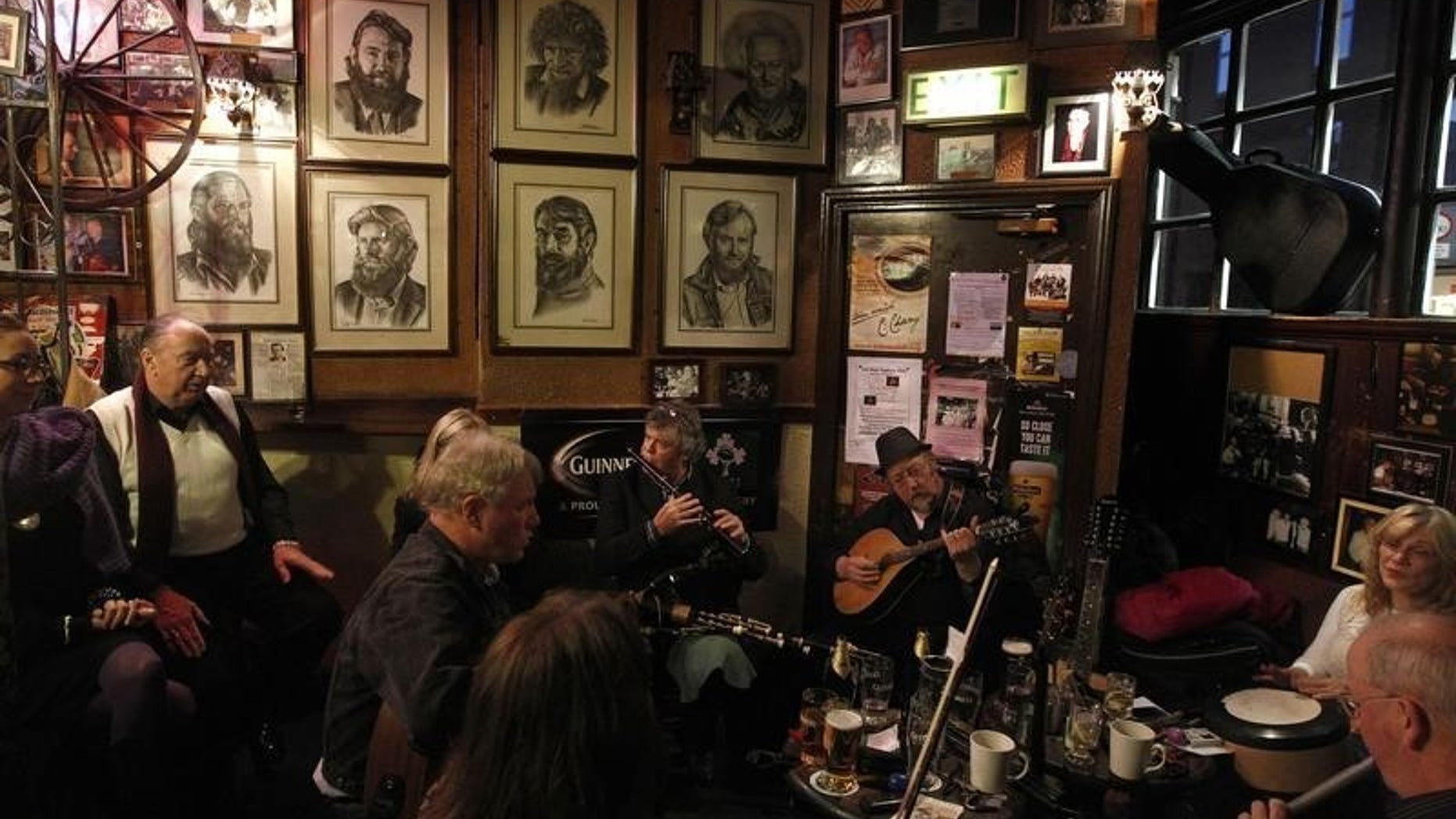 Musicians play Irish traditional music in a pub in central Dublin November 21, 2010. REUTERS/Cathal McNaughton