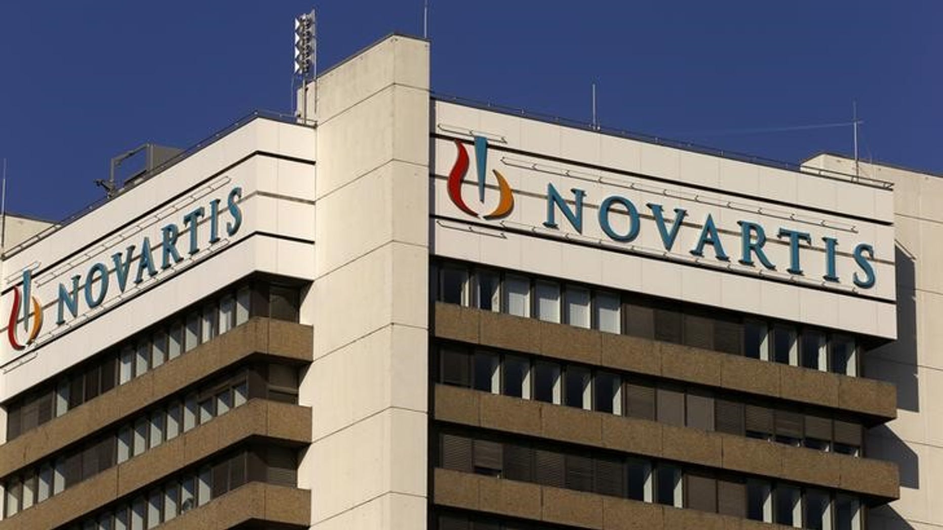 The logo of Swiss pharmaceutical company Novartis is seen on its headquarters building in Basel, Switzerland October 27, 2015. Novartis agreed in principle to pay $390 million to settle U.S. allegations that it used kickbacks to speciality pharmacies to push sales of some drugs, the Swiss company said on Tuesday, hitting third-quarter earnings. REUTERS/Arnd Wiegmann