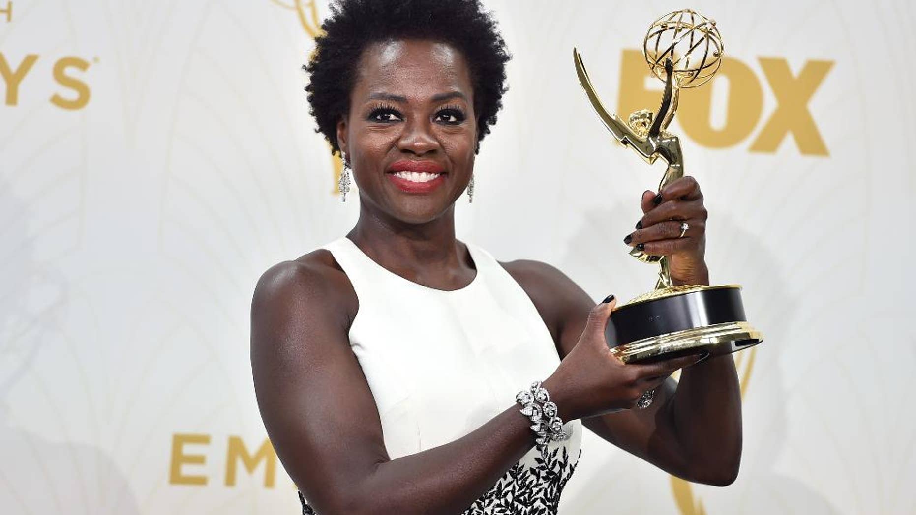 Viola Davis poses in the press room with the award for outstanding lead actress in a drama series for “How to Get Away With Murder” at the 67th Primetime Emmy Awards on Sunday, Sept. 20, 2015, at the Microsoft Theater in Los Angeles. (Photo by Jordan Strauss/Invision/AP)