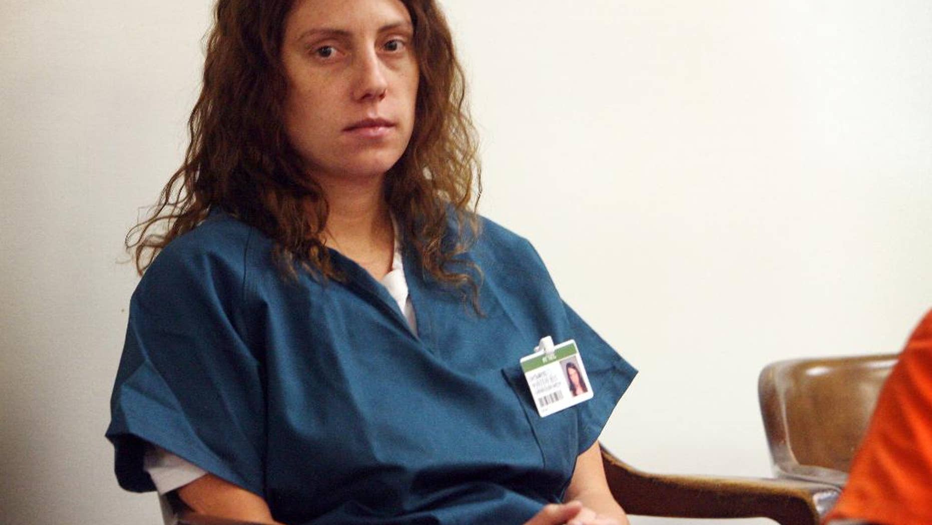 FILE - This July 31, 2013 file photo shows former Citrus Valley High teacher Laura Whitehurst awaits a hearing on in Superior Court in San Bernardino, Calif. The former student who fathered a child with Whitehurst will receive a $6 million settlement from a California school district. Vince Finaldi, an attorney for the former Redlands high school student, announced the deal on Friday, Aug. 19, 2016. (Kurt Miller/The Press-Enterprise via AP, File)
