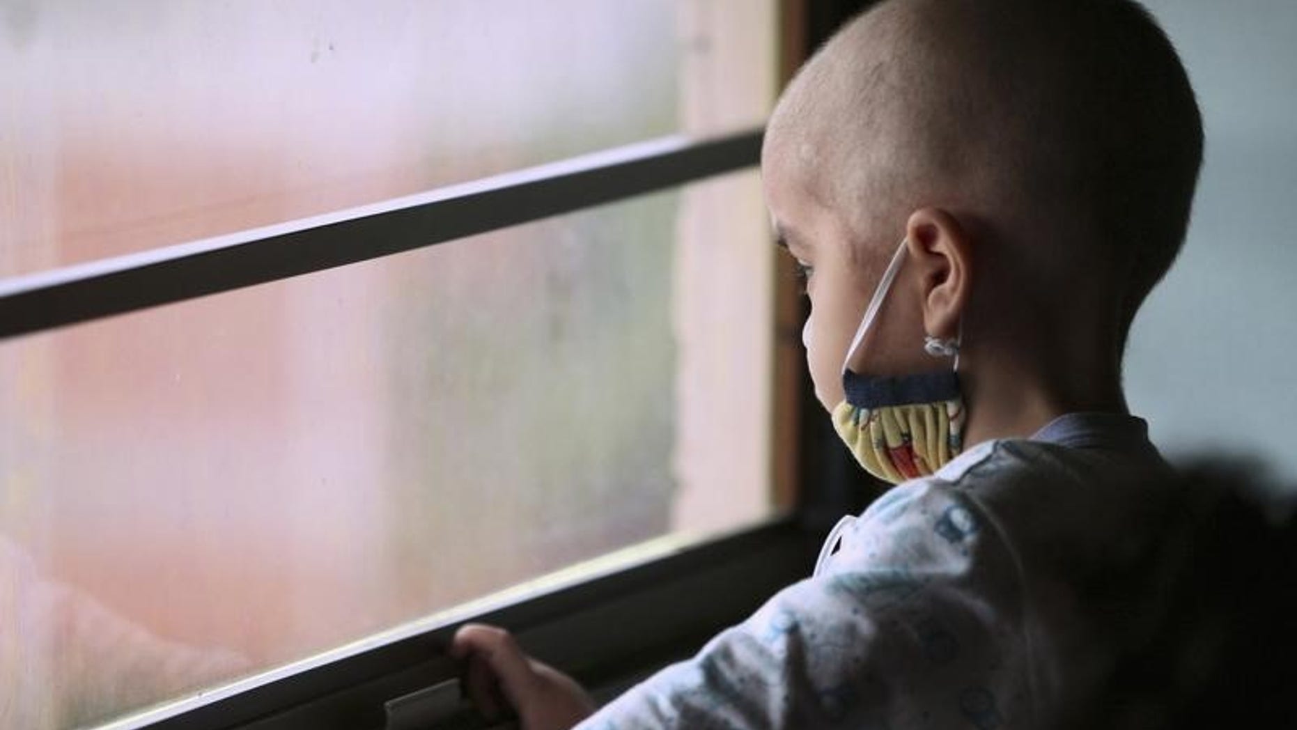 Manuel Andres Sequera, 2, looks out the window while receiving chemotherapy treatment at a paediatric hospital in Maracaibo, Venezuela. November 29, 2011. REUTERS/Isaac Urrutia