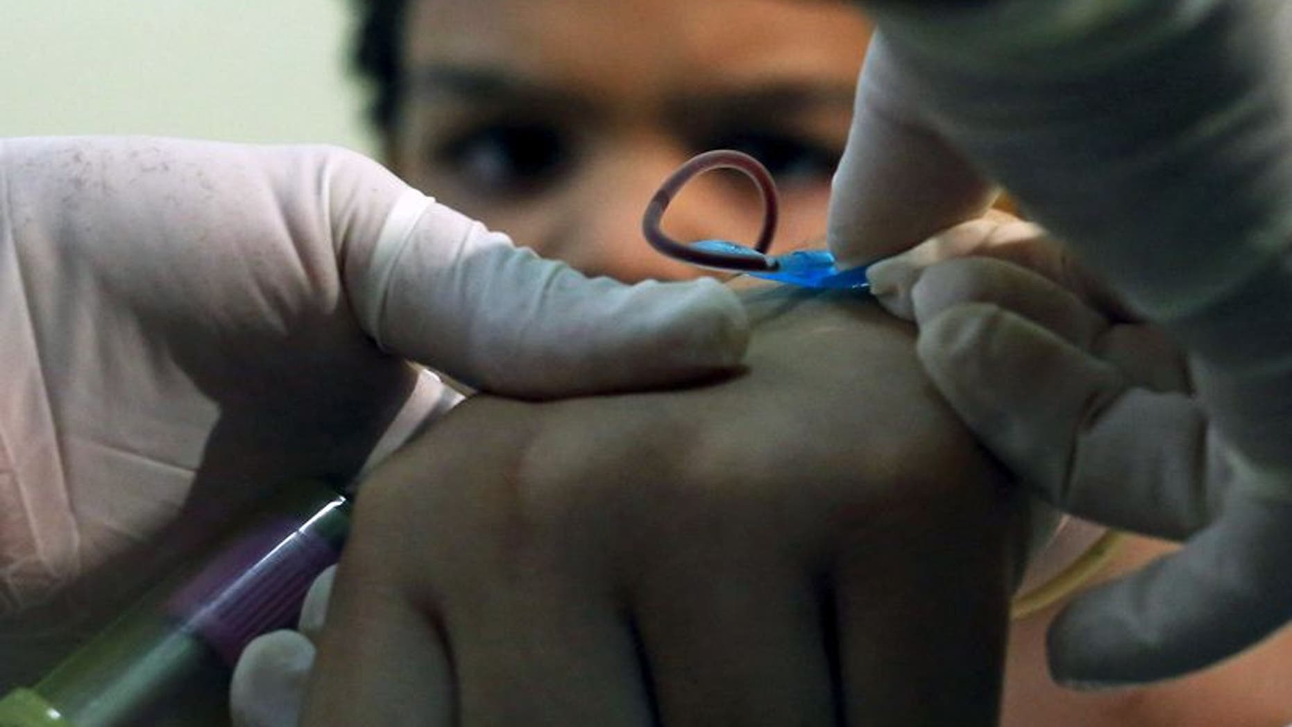 A health agent collects blood from a child with a new test kit that rapidly diagnoses three different mosquito-borne viruses in Sao Paulo, Brazil, January 18, 2016. REUTERS/Rodrigo Paiva