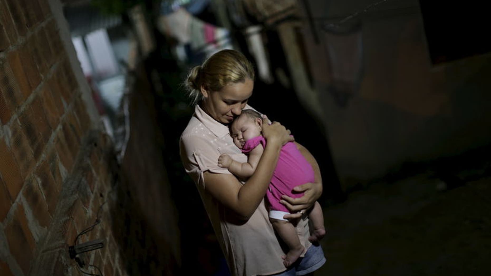 Gleyce Kelly embraces her daughter Maria Geovana, who has microcephaly, in Recife, Brazil, January 25, 2016. REUTERS/Ueslei Marcelino