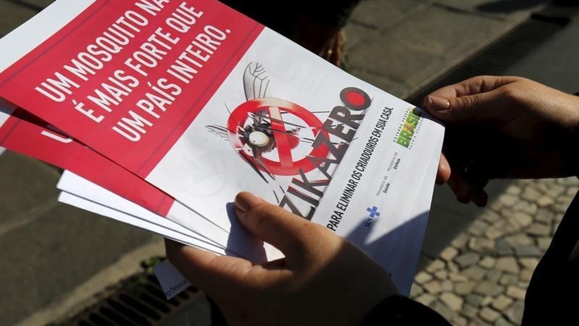 A Brazilian Army soldier shows pamphlets during the National Day of Mobilization Zika Zero in Rio de Janeiro
