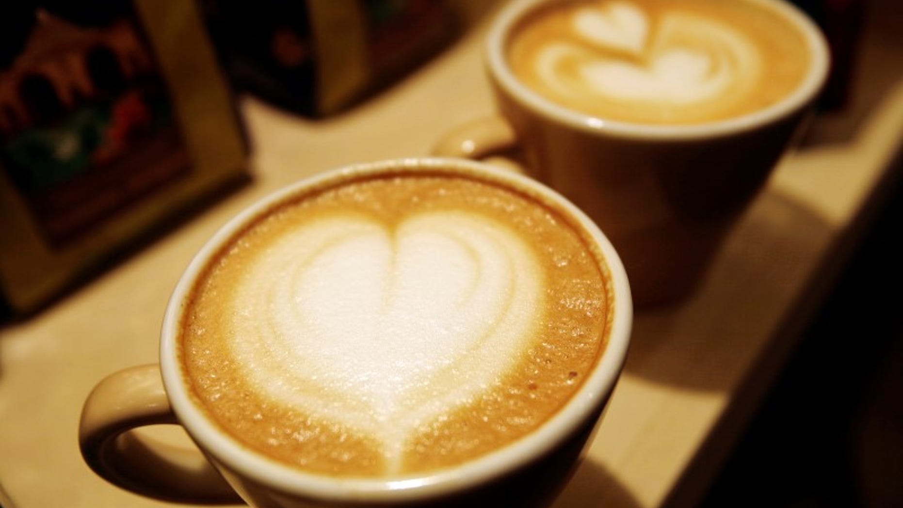 Cups of cappuccino sit on a table during the World Coffee Conference in Guatemala City