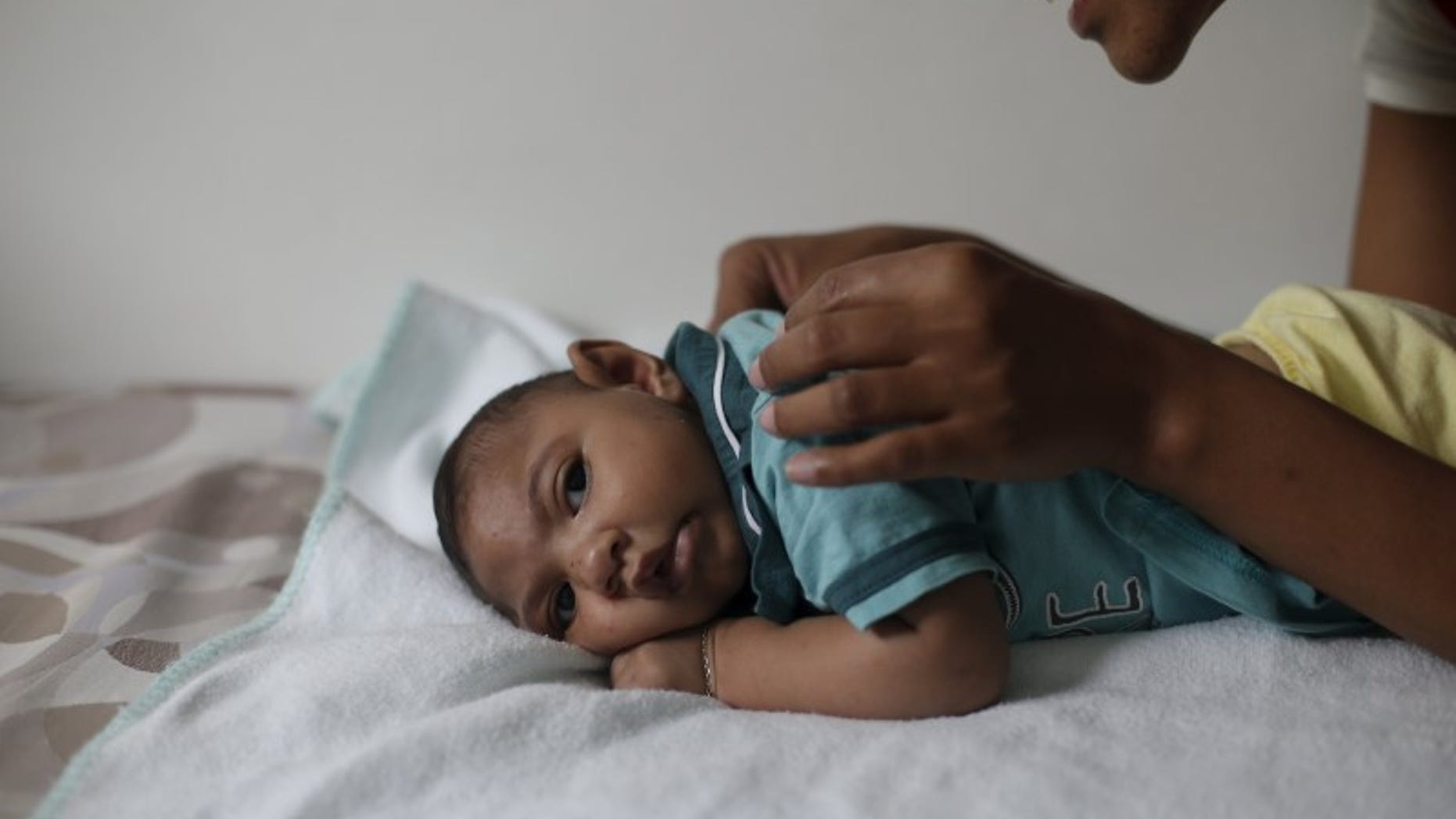 Mariam Araujo, plays with Lucas, her second child and born with microcephaly as they wait for a physiotherapy session in Pedro I hospital in Campina Grande