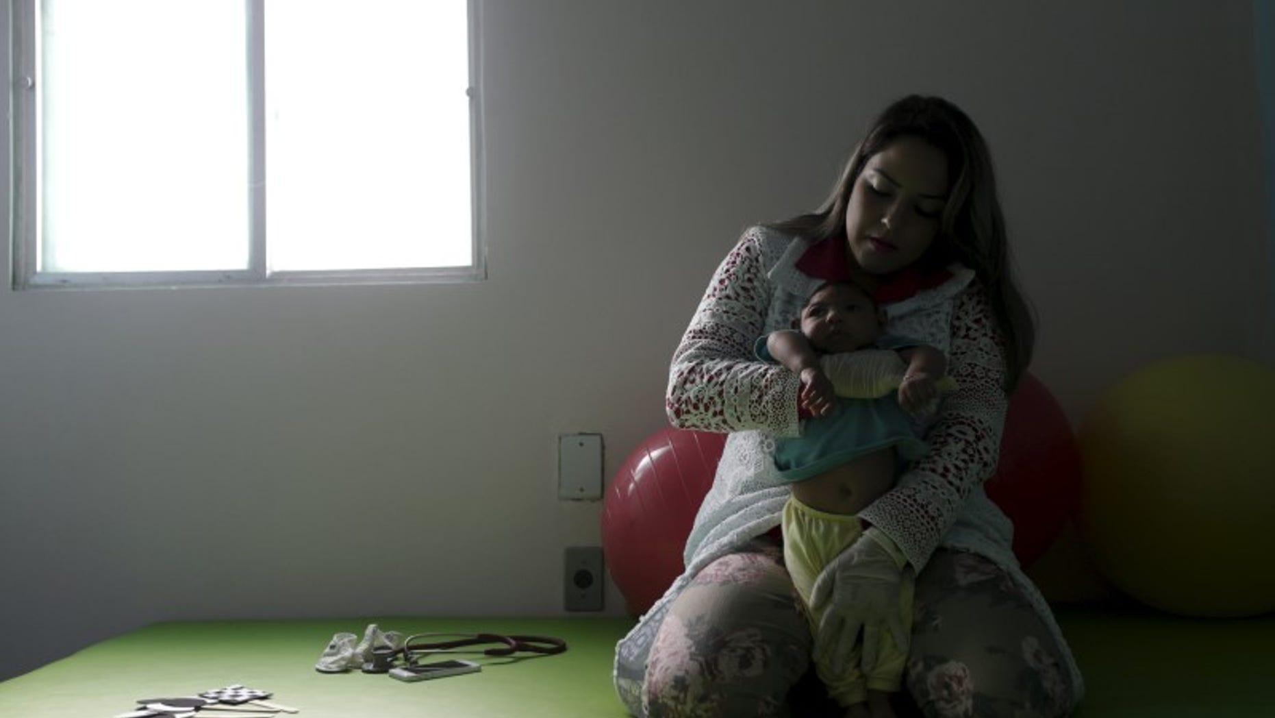 Physiotherapist Leal does exercises with Lucas, 4-months old, who is Miriam Araujo's second child and born with microcephaly in Pedro I hospital in Campina Grande