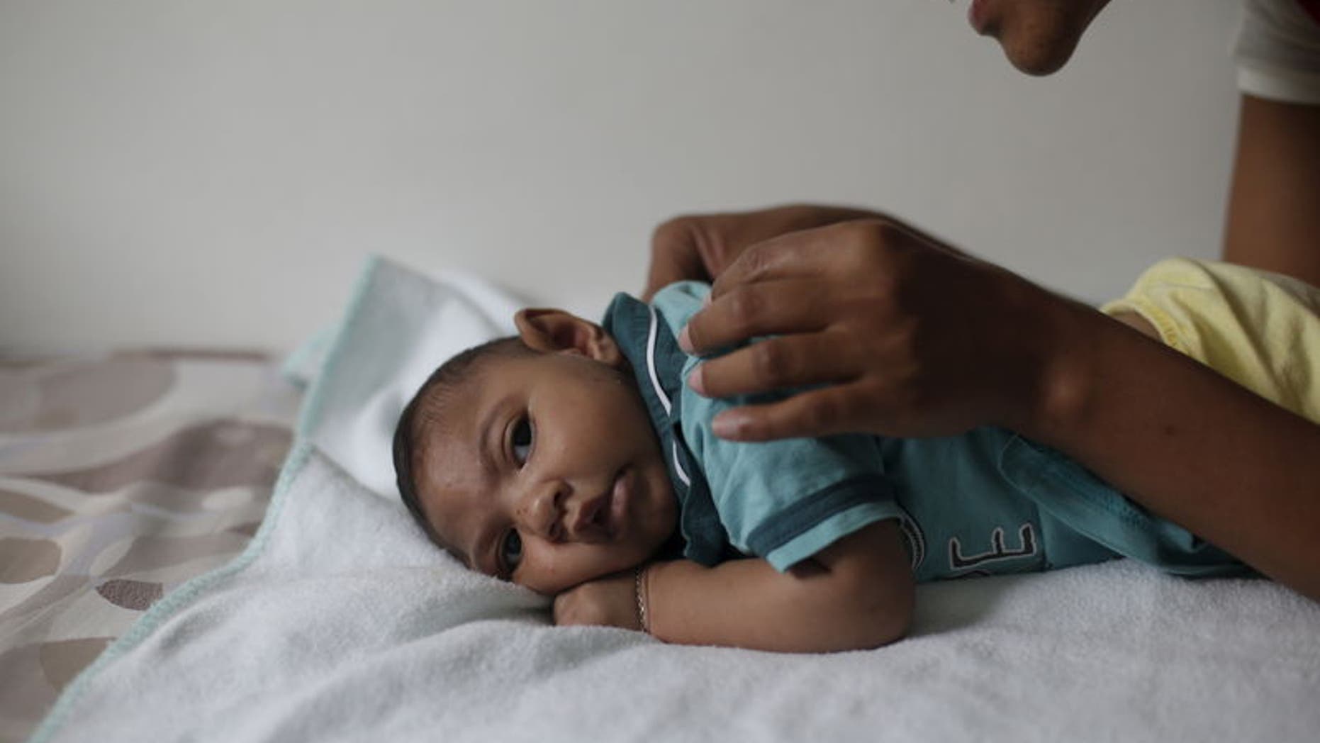 Mariam Araujo, plays with Lucas, her second child and born with microcephaly as they wait for a physiotherapy session in Pedro I hospital in Campina Grande