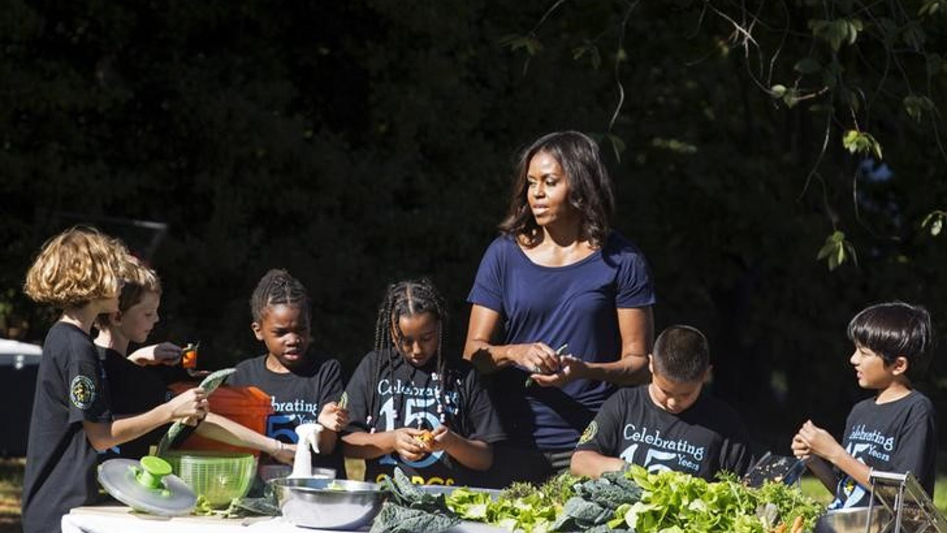 U.S. first lady Michelle Obama prepares lunch with elementary students during the annual fall harvest of the White House Kitchen Garden