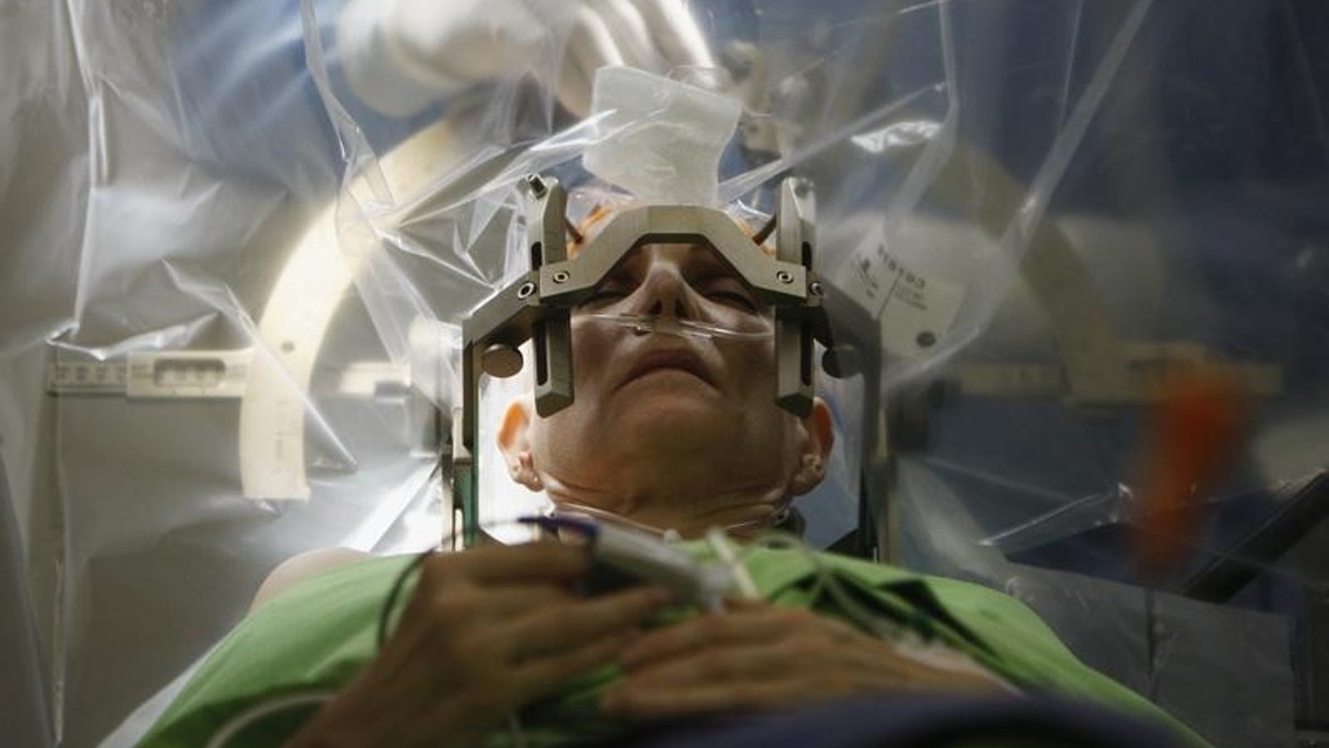 A woman lies on an operating table during a brain surgery at the National Neurology Institute in Budapest