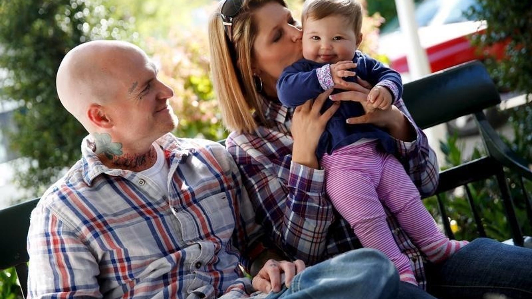 Donnie Gooding and Katy Yeager Gooding hold their baby Kennedy in Barboursville, West Virginia