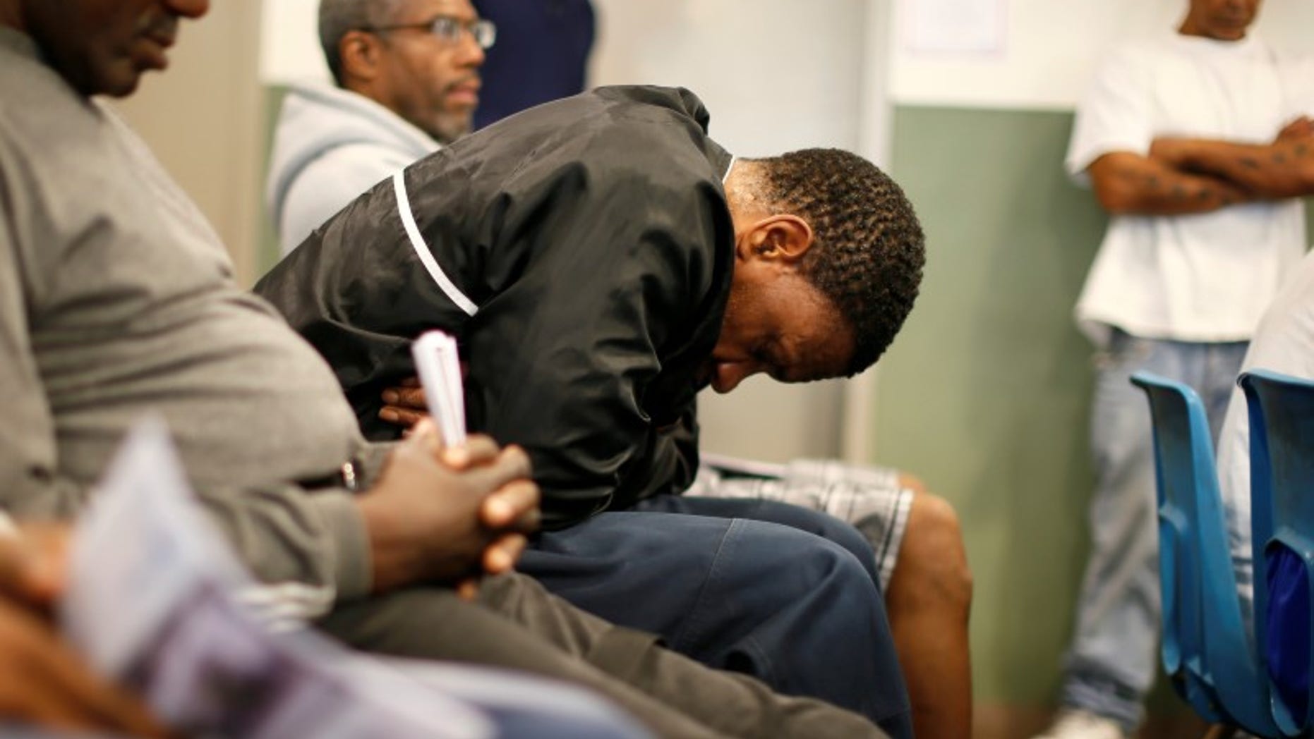 U.S. military veterans listen to speeches during a Veterans Day observance for homeless veterans at The Midnight Mission shelter on skid row in Los Angeles