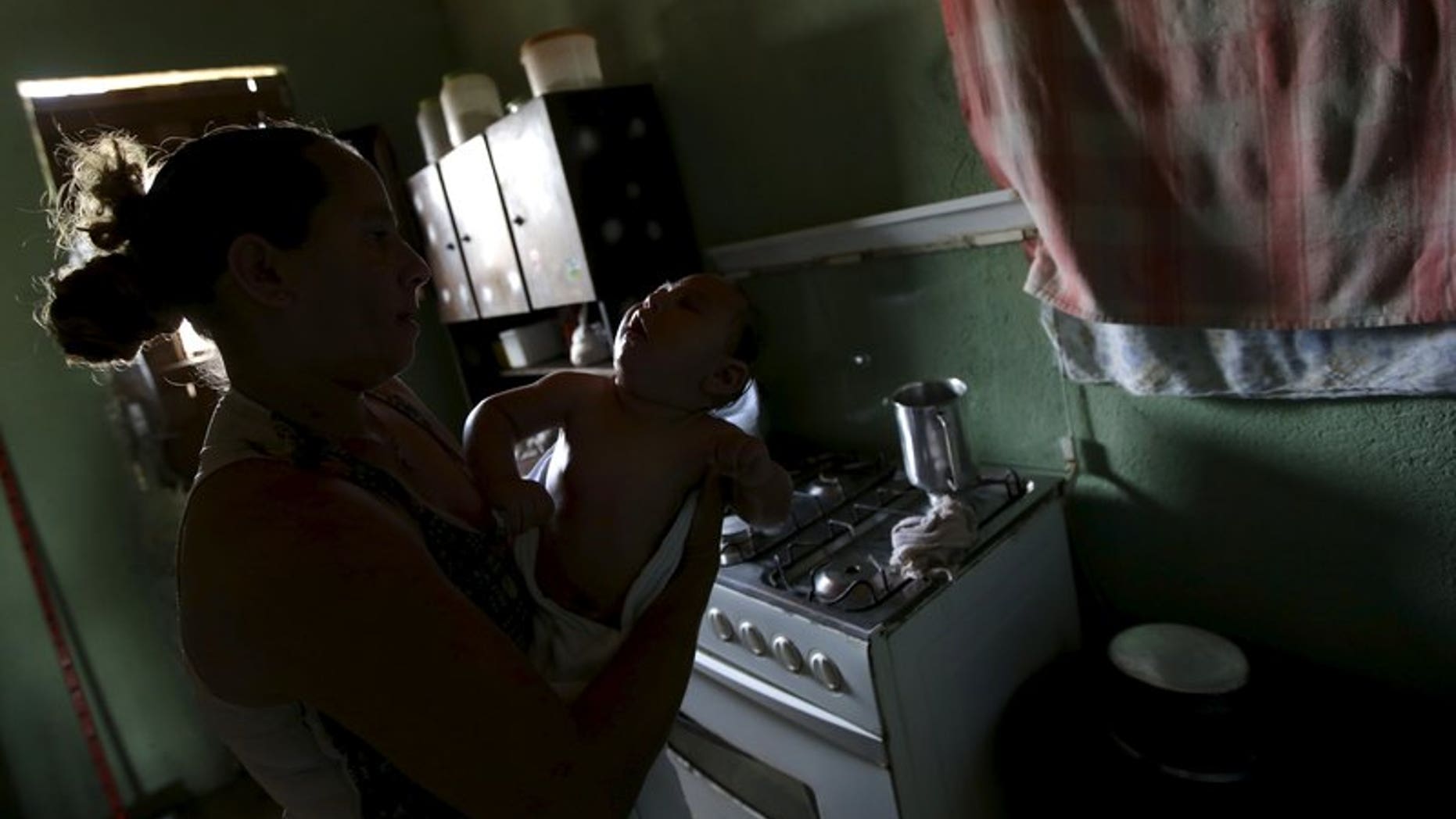 Josemary da Silva, 34, wipes Gilberto, five months old, who is her fifth child and born with microcephaly, after giving him a bath at her house in Algodao de Jandaira