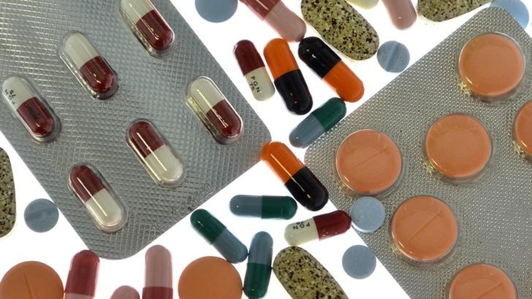 Pharmaceutical tablets and capsules in blister packs are arranged on table in illustration picture in Ljubljana