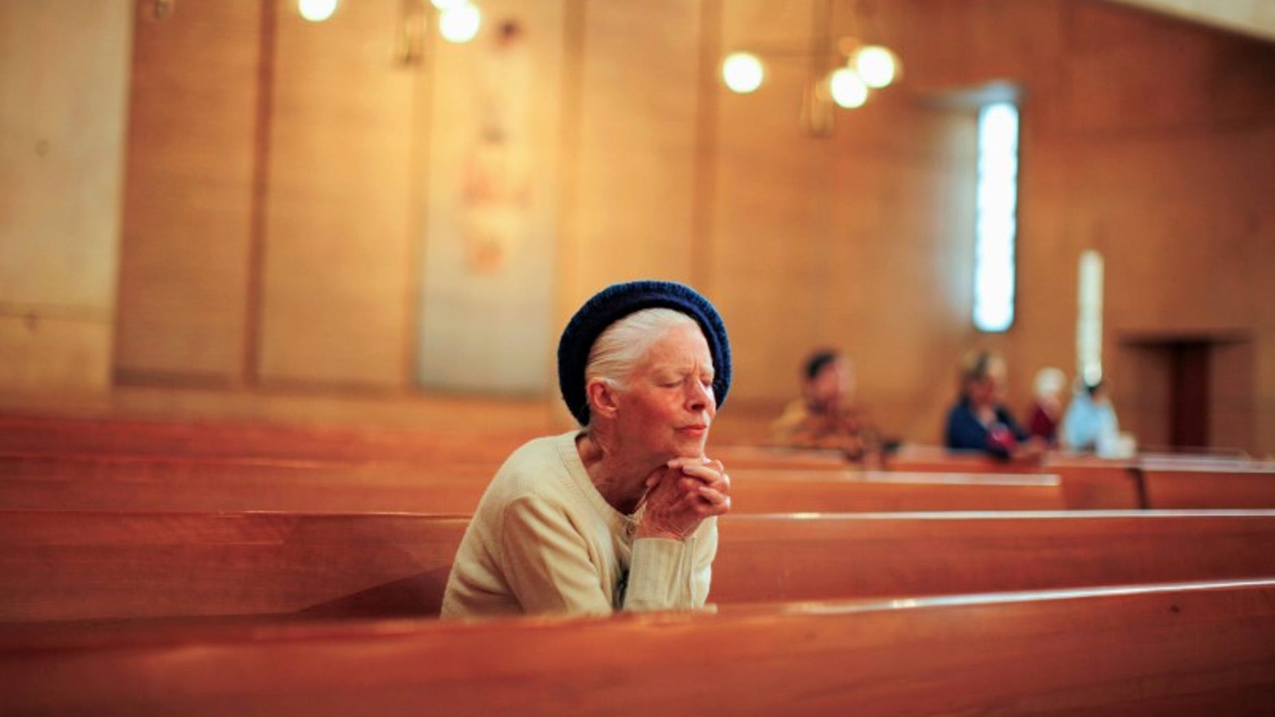 People pray after learning of the newly elected Pope Francis at the Cathedral of Our Lady of the Angels in Los Angeles, California