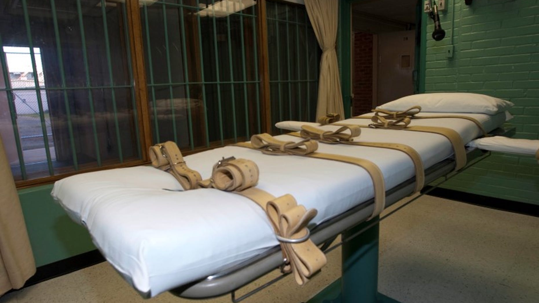 The death chamber and the steel bars of the viewing room are seen at the state penitentiary in Huntsville, Texas