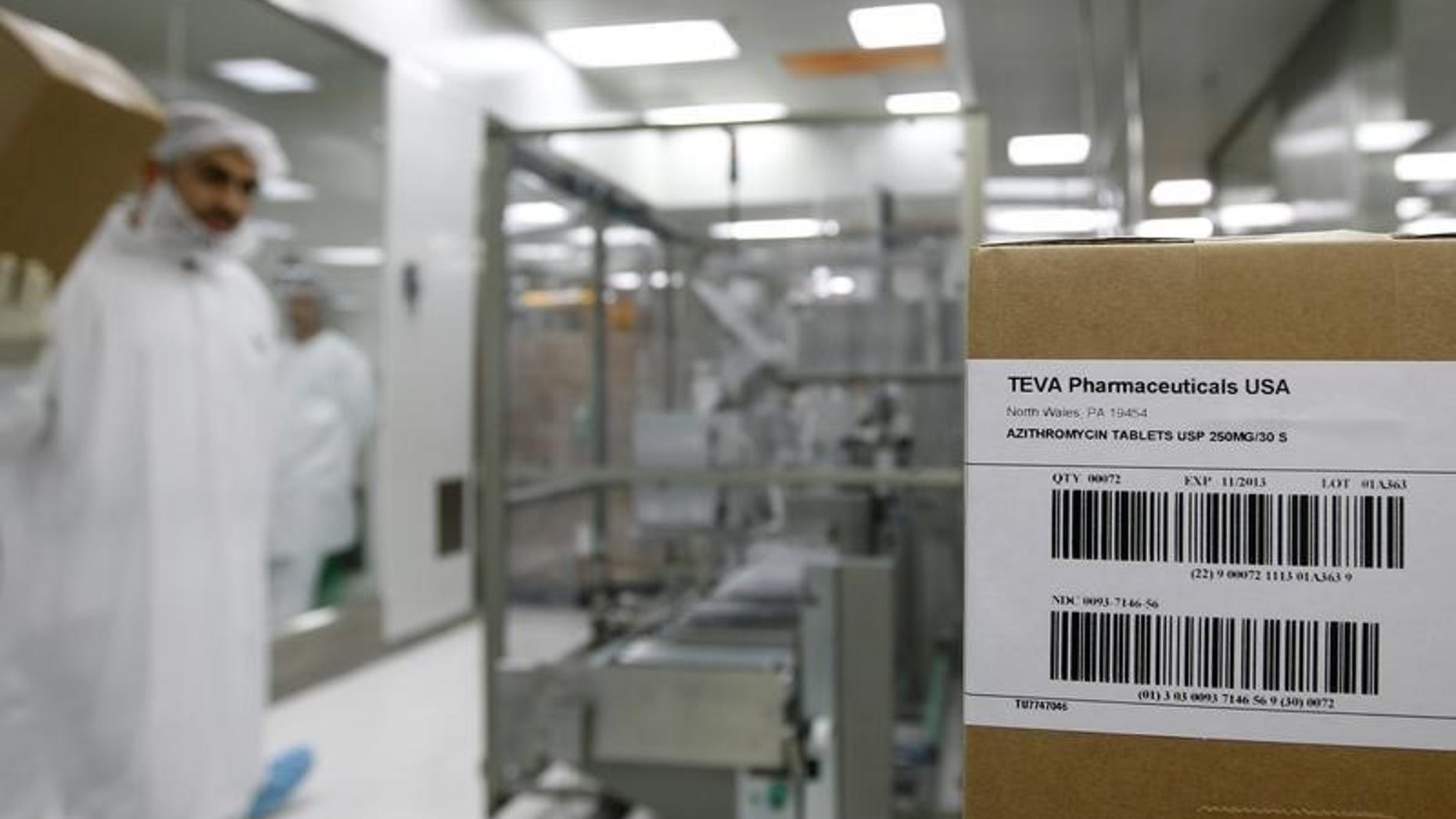 An employee of Teva Pharmaceutical Industries carries a box in Jerusalem oral solid dosage plant