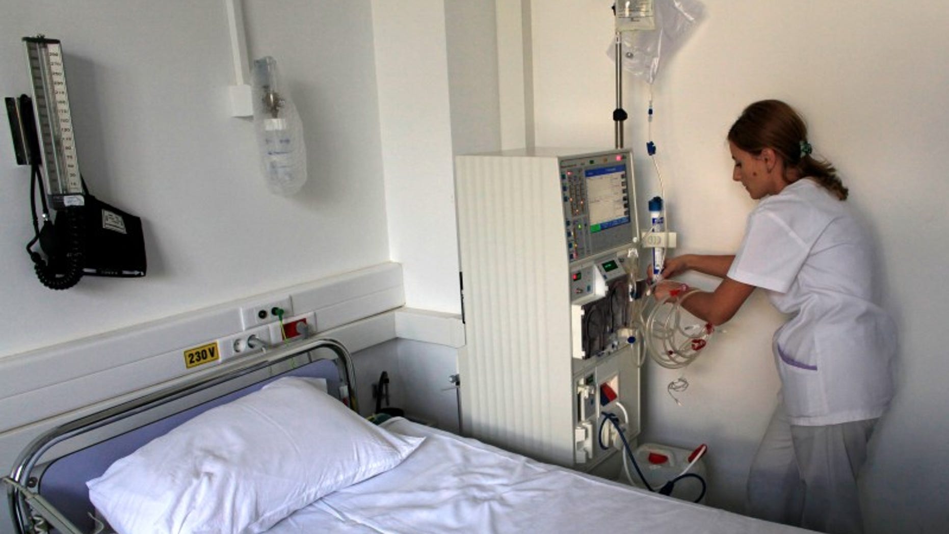 Nurse Georgiana Stefan prepares a dialysis machine for a diabetes patient at Nicolae Paulescu National Institute for Diabetes, Nutrition and Metabolic Diseases in Bucharest