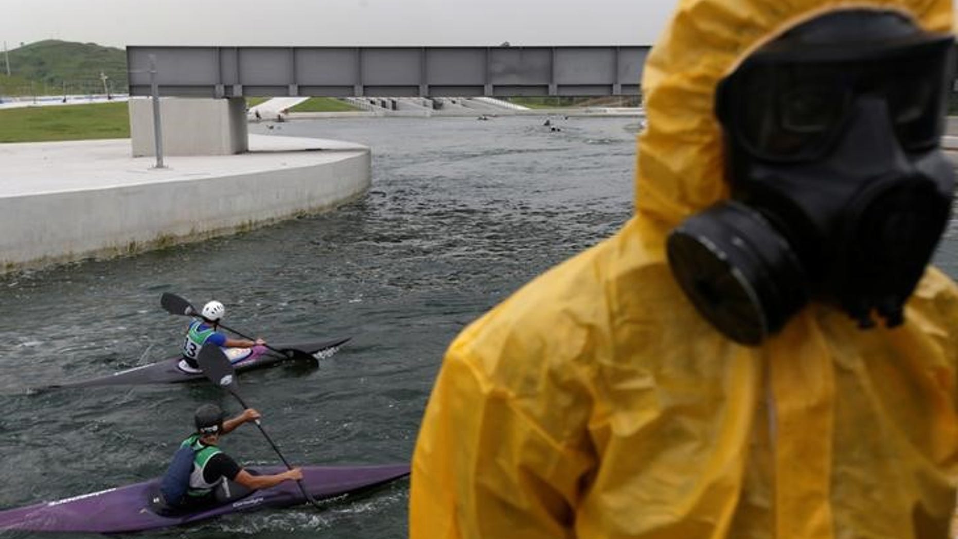 Athletes attend a training session at 2016 Rio Olympics Games' Canoe Slalom Circuit as Brazilian Army soldiers take part in a simulation of decontamination of multiple victims during a a training in Rio de Janeiro