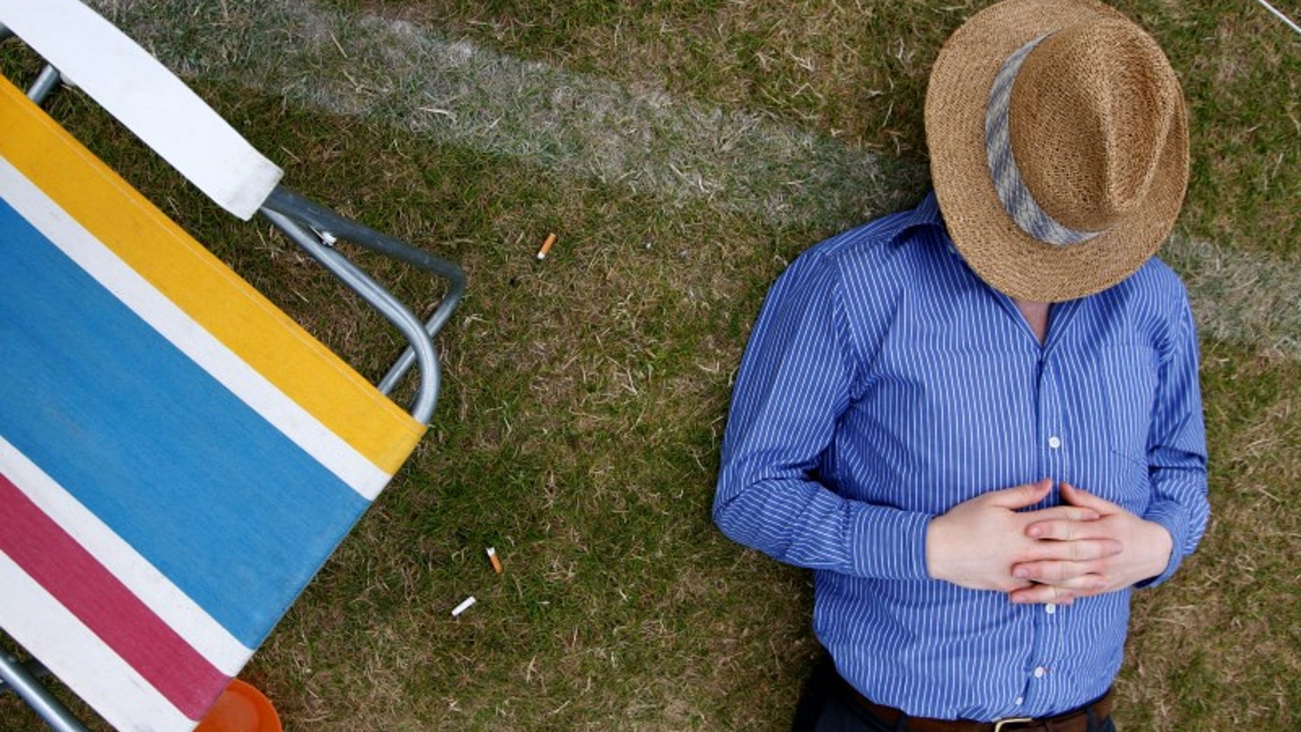 Man sleeps during final of Gold Cup British Open Polo Championship match at Cowdray Park