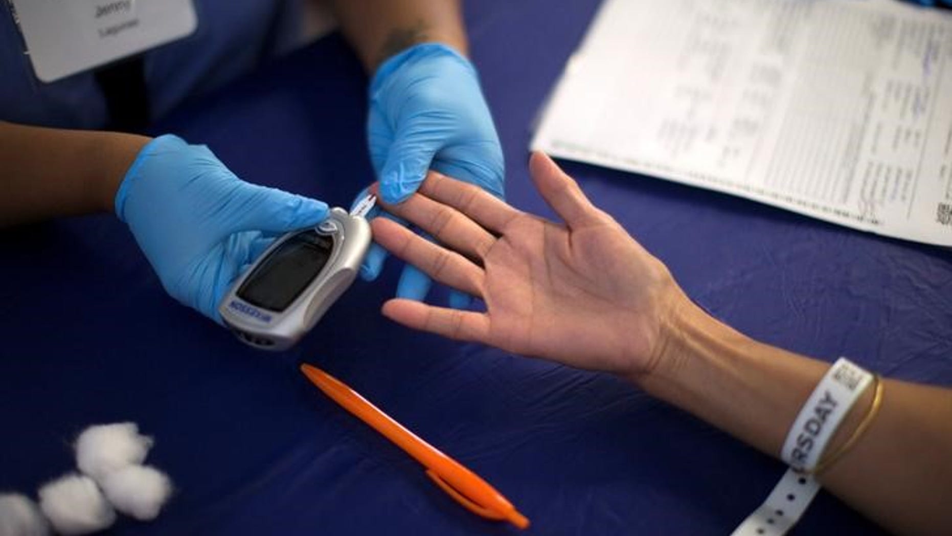 A person receives a test for diabetes during Care Harbor LA free medical clinic in Los Angeles