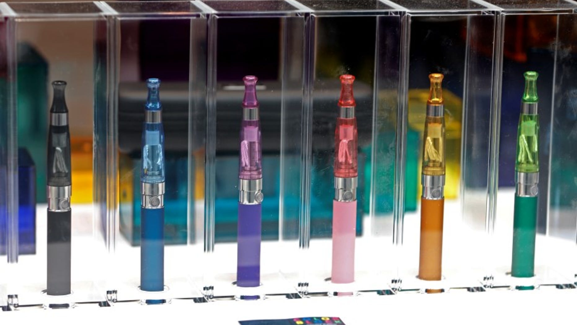 A window display with different colour models of electronic cigarettes is seen in a shop in Paris
