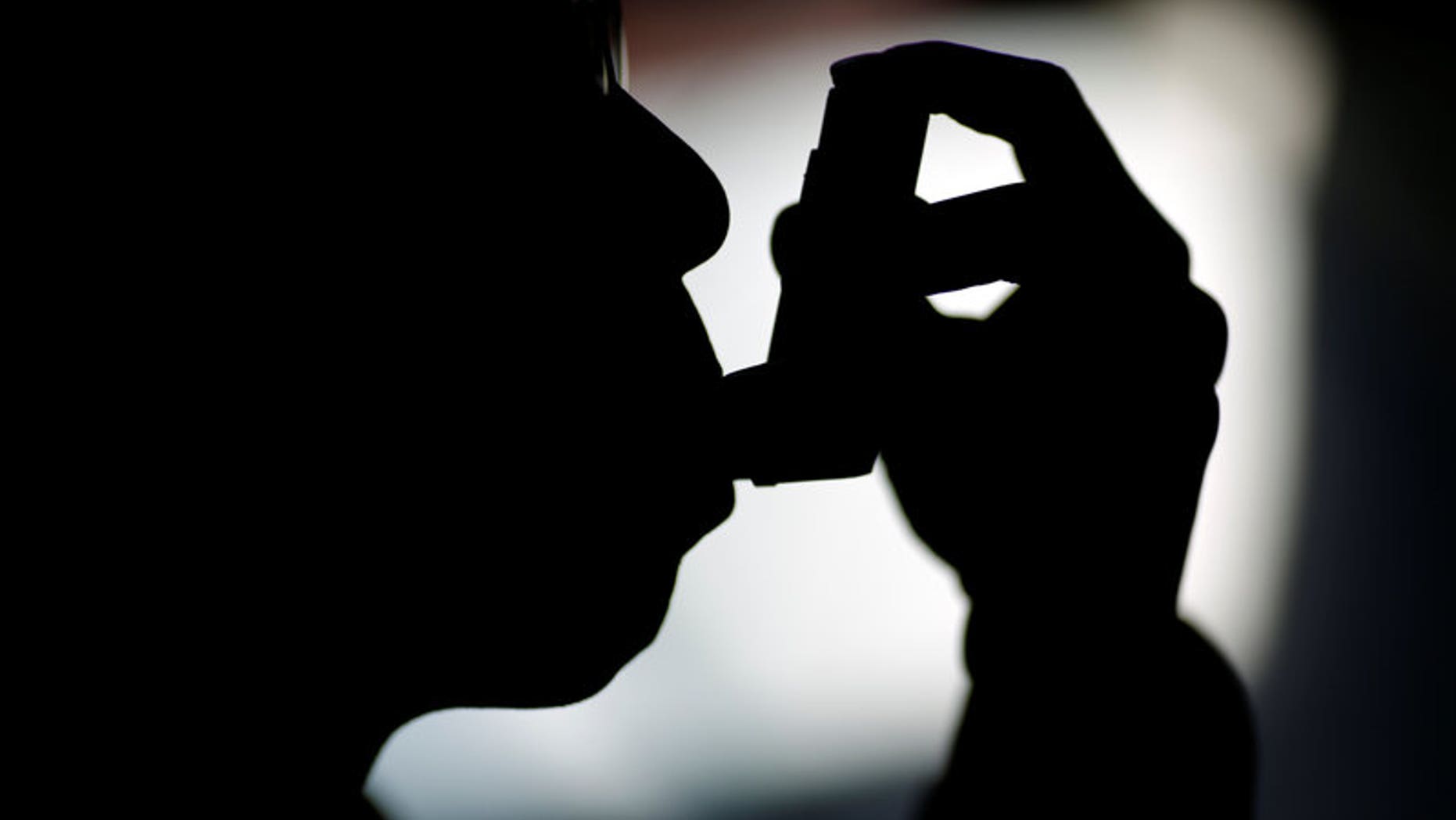 FILE PHOTO A man uses an inhaler at his house in Beijing, China