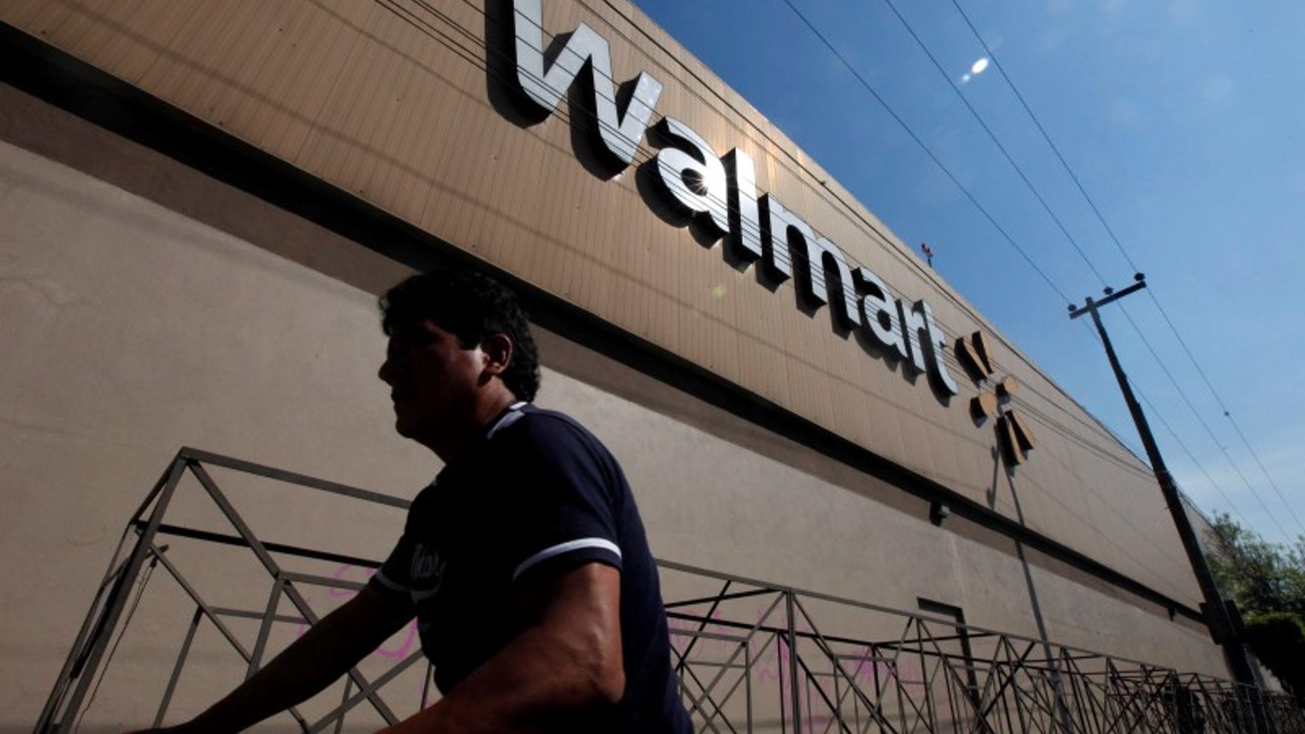 A person walks outside a Wal-Mart store in Mexico City