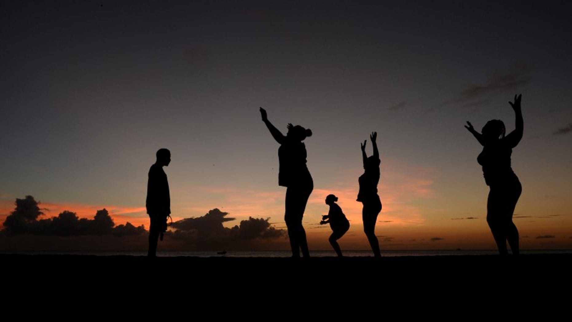 File picture of women exercising in front of a trainer as the sun sets near Kensington Oval in Bridgetown, Barbados