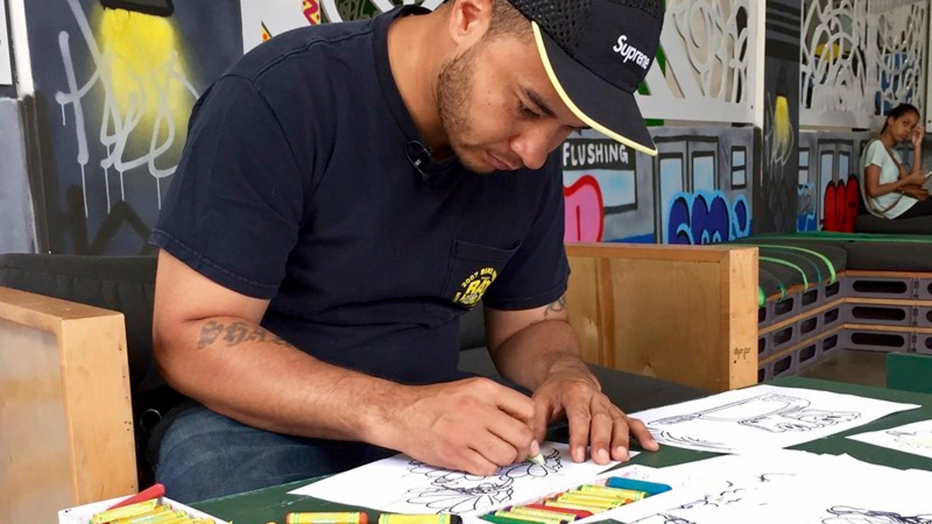 Artist Shawn Crawford draws illustrations of mosquitos for an educational brochure about Zika, in New York
