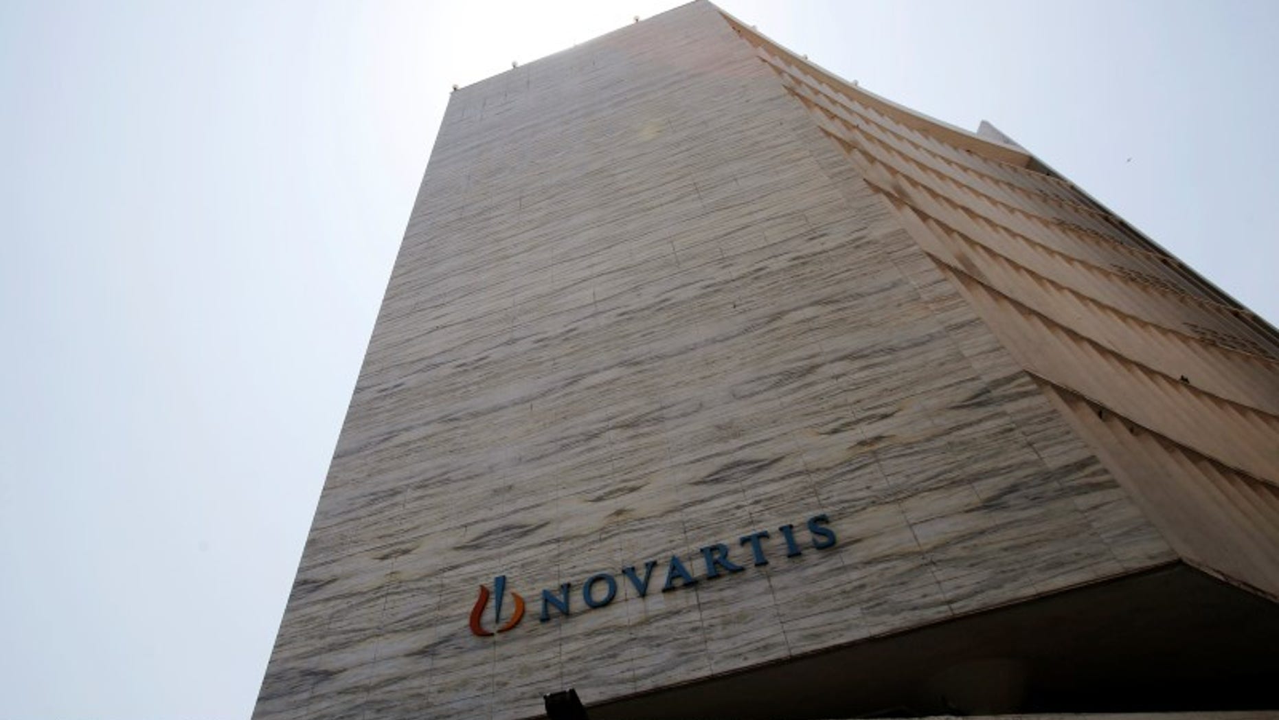 A Novartis logo is pictured on its headquarters building in Mumbai
