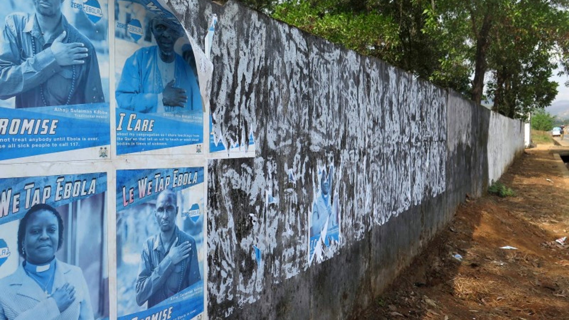 Ebola awareness posters are seen peeling off the wall in Freetown