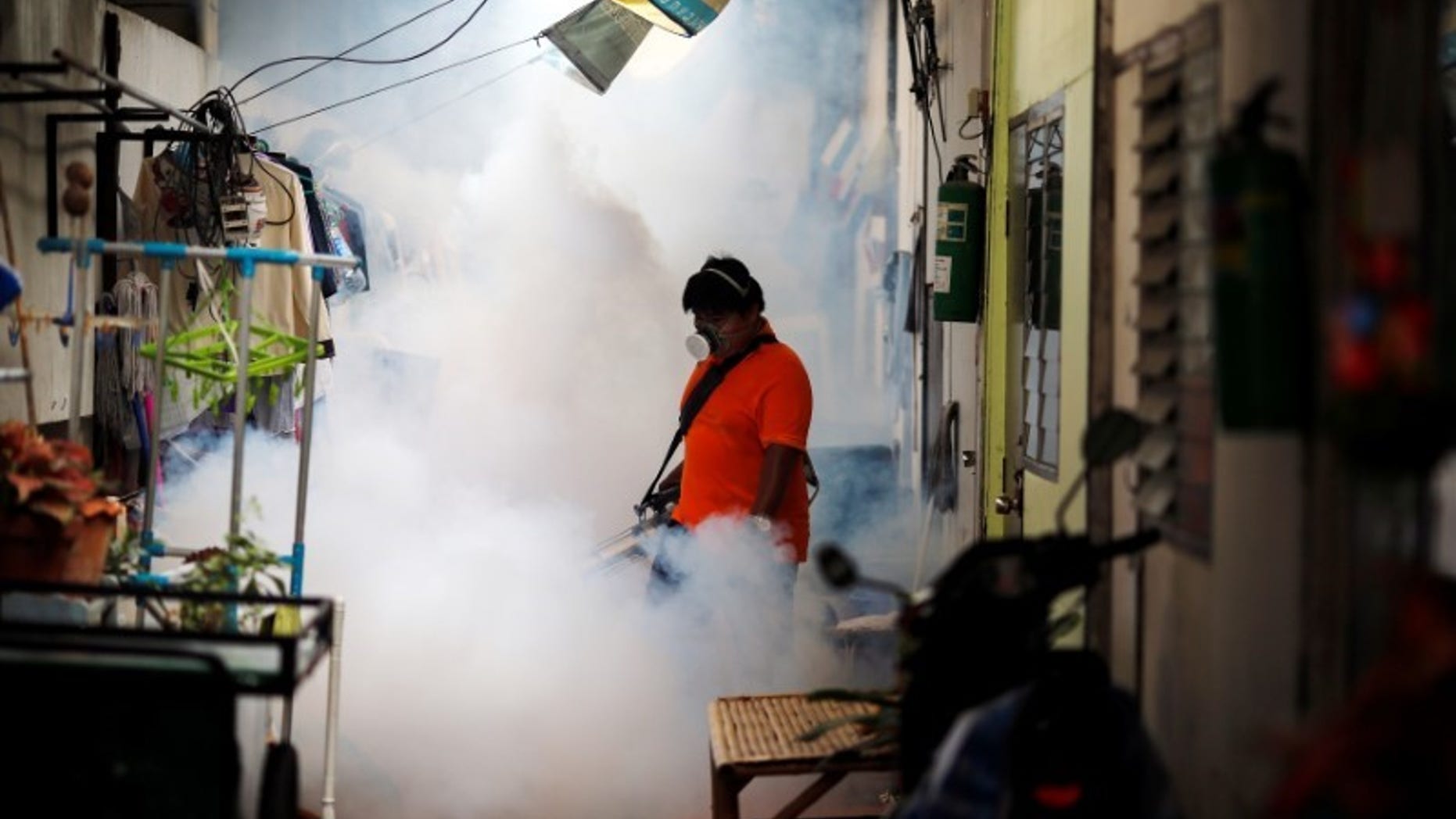 A city worker fumigates the area to control the spread of mosquitoes at a university in Bangkok