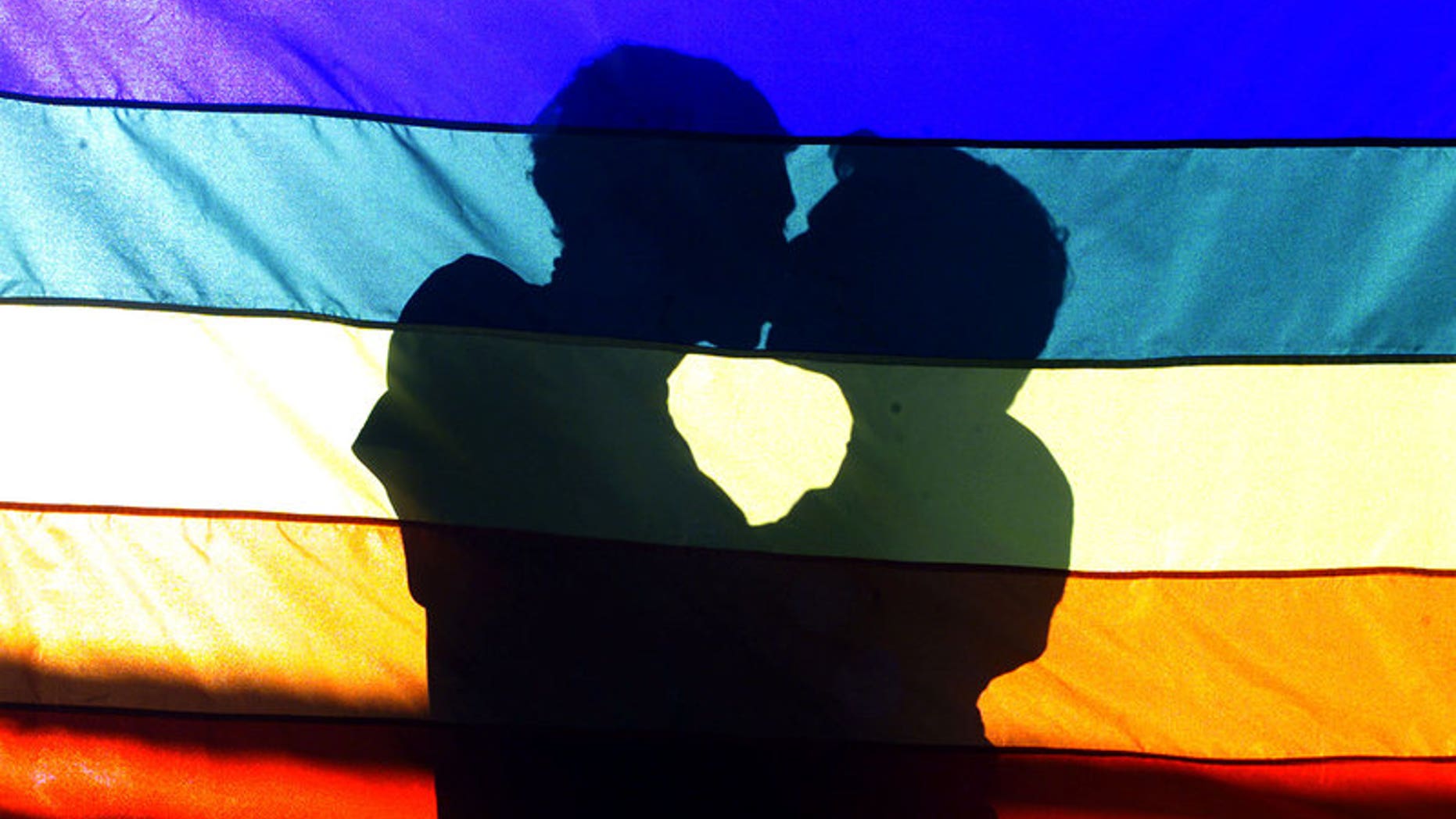 Men kiss each other during a gay protest in front at Nossa Senhora da Paz church in the Ipamena neighborhood in Rio de Janeiro
