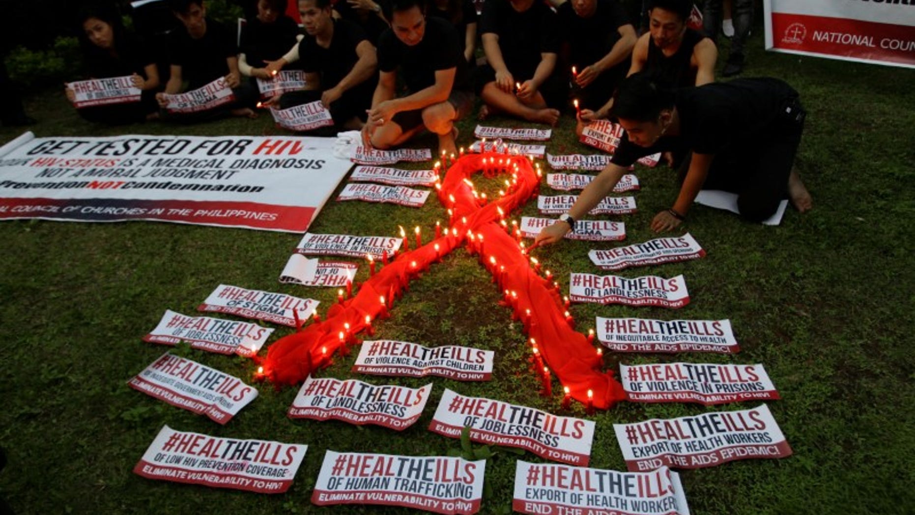 People light candles to mark World AIDS day in Quezon city, Metro Manila, Philippines