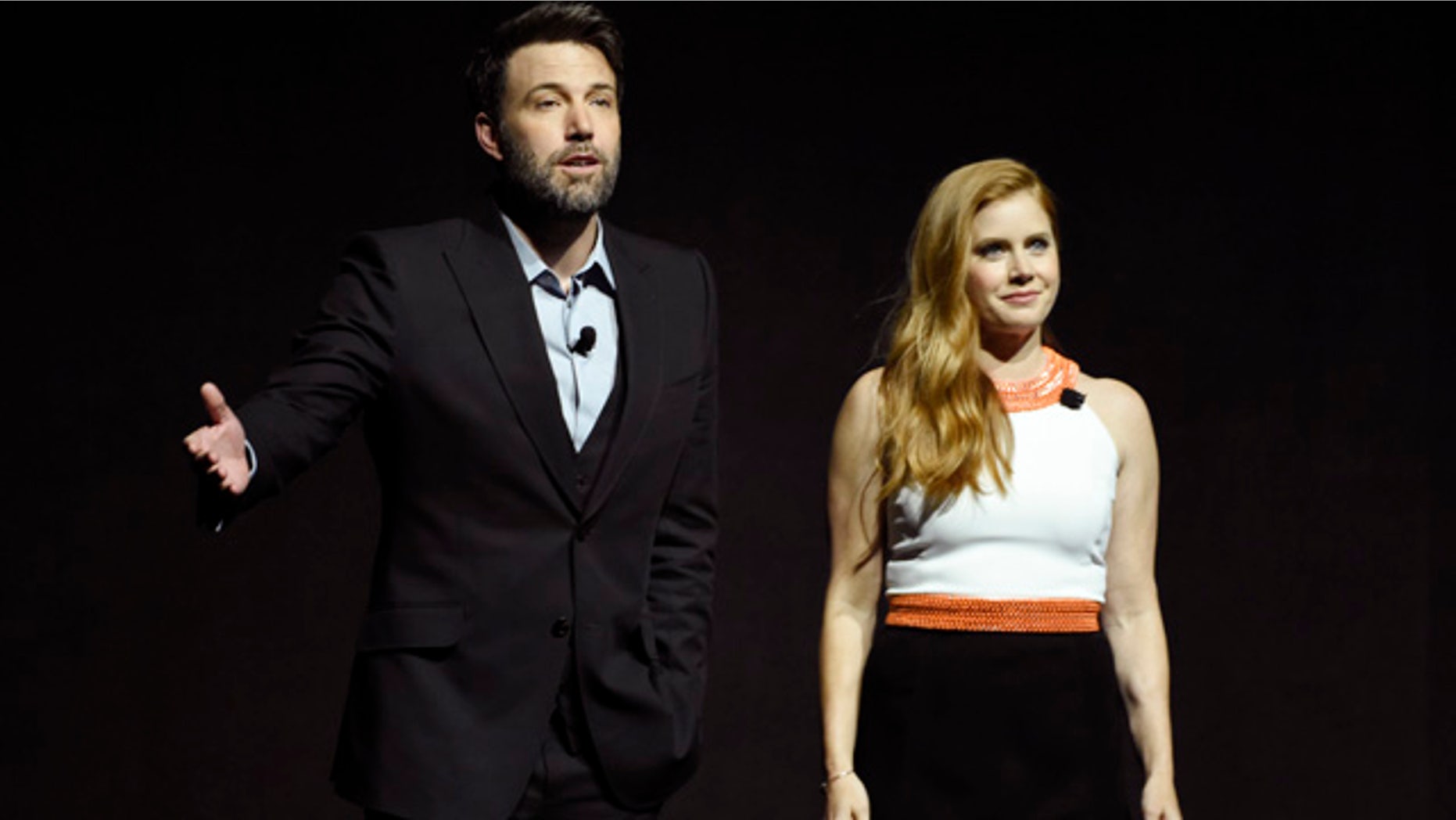 April 12, 2016: Ben Affleck and Amy Adams, cast members in the film 'Batman v Superman: Dawn of Justice,' address the audience during the Warner Bros. presentation at CinemaCon 2016, the official convention of the National Association of Theatre Owners (NATO), at Caesars Palace in Las Vegas. (Photo by Chris Pizzello/Invision/AP)