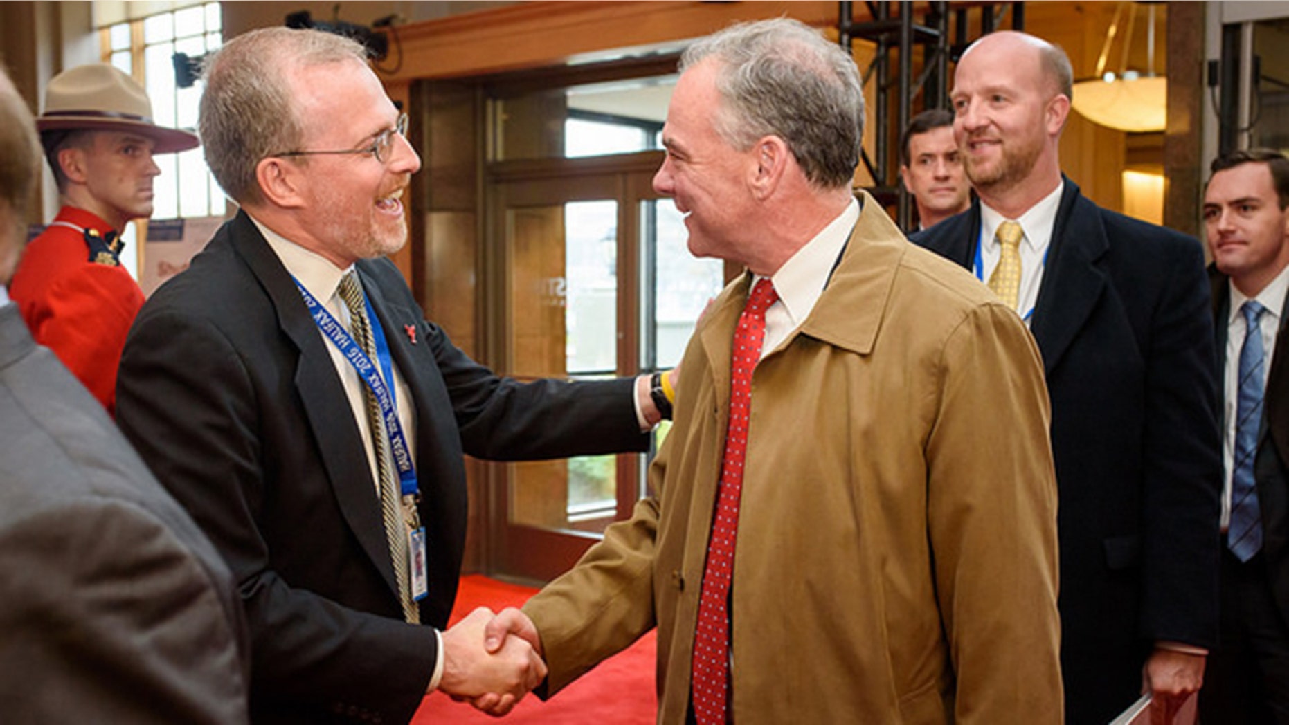 David Kramer greets Sen. Tim Kaine at the Halifax International Security Forum in November 2016.