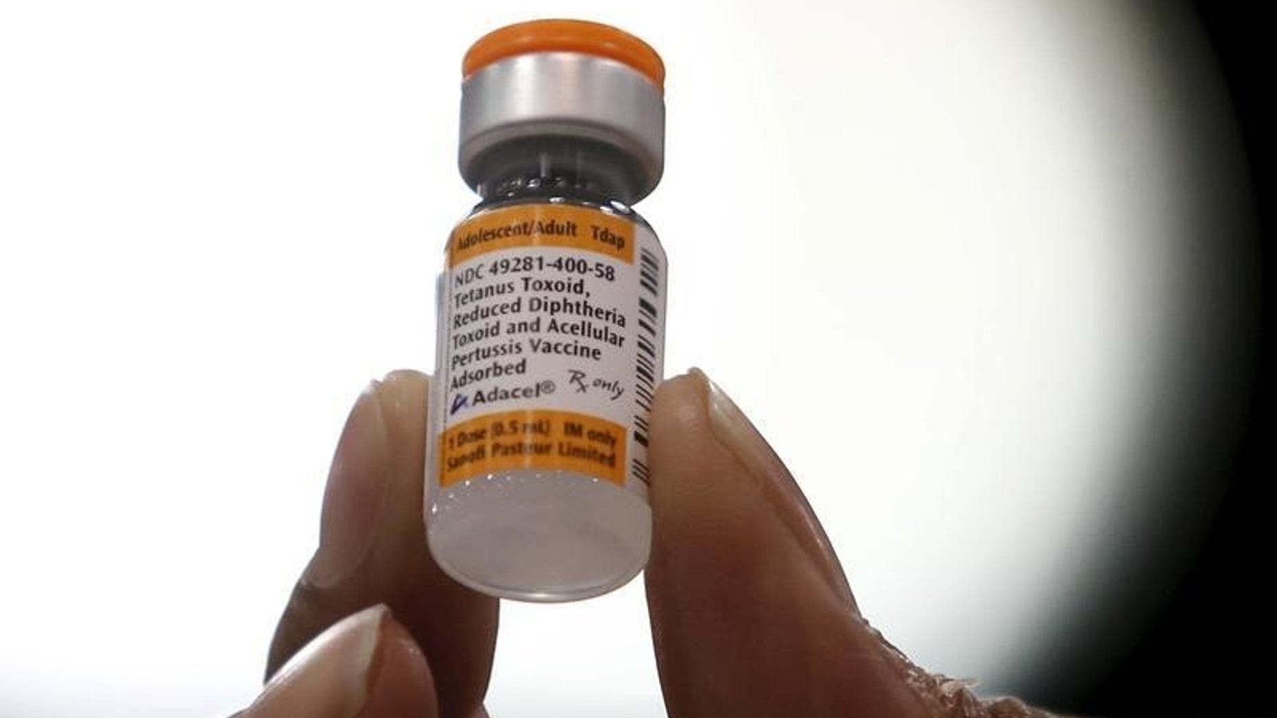 A nurse displays a tetanus, diphtheria and pertussis whooping cough vaccine at a free medical and dental health clinic in Los Angeles